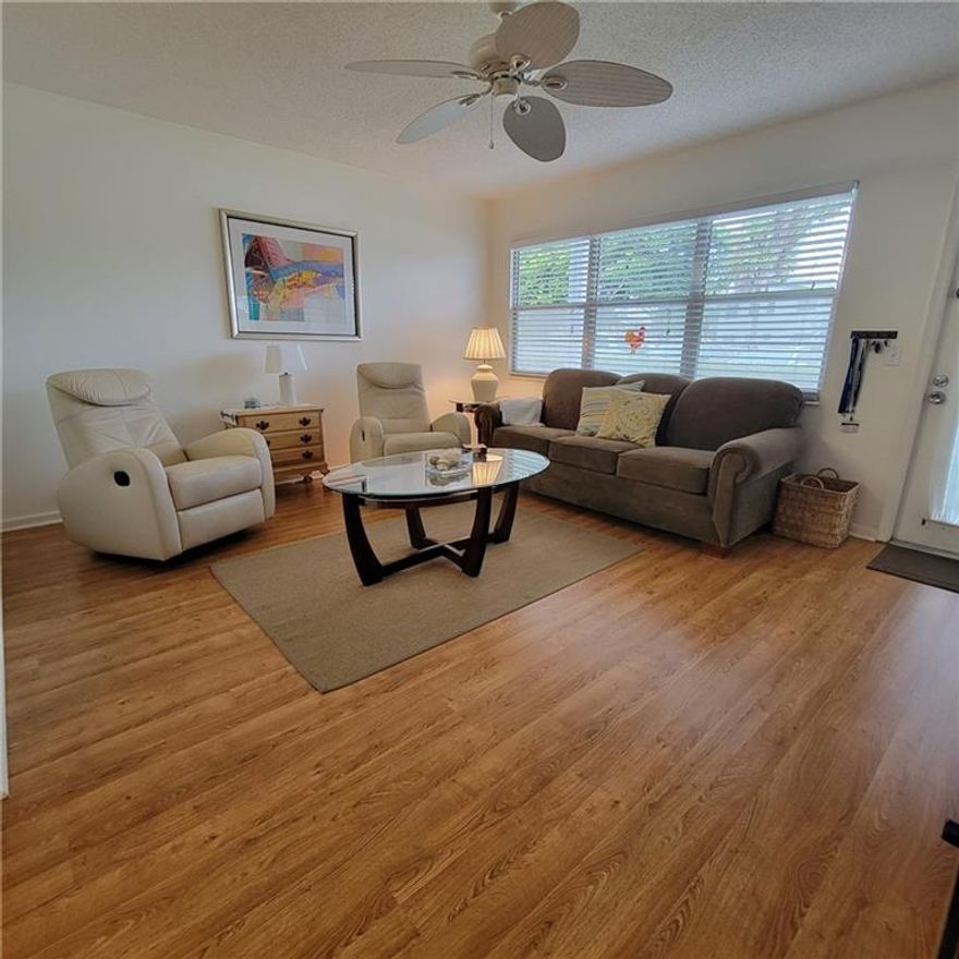 Great 1st floor unit in wonderful Harwood C. Beautiful Water View. One Bedroom, One Bath, with a great walk in shower. Newer Kitchen with wood cabinets. Must see the lovely Laminated floors thru out except in Sunroom which has tile. Home is furnished and ready for you. This well maintained building is surrounded by water and wonderful views. 3.3 Miles to beautiful Deerfield Beach. The parking spot is right outside your door  You also have a large storage unit in the laundry room #1010. Everything you need is in this unit dishes, pots & pans, silverware.