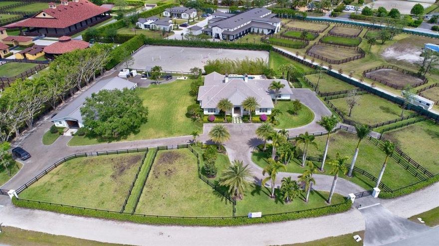 Less than a half mile hack to the Palm Beach International Equestrian Center and The Winter Equestrian Festival, this 2.46 acre farm has a 10-stall, CBS construction center aisle barn with feed and tack rooms, wash racks, and groom's apartment with full bathroom plus additional half bath, and full laundry facilities. Separate, gated entrances to the barn and house. 6 paddocks, dog run, sand ring (200' x 110' approx). The entire property - house, barn, ring and site work were totally renovated in 2016. The home features high end finishes such as impact glass windows, electric patio screens, tile throughout, home surveillance system. New pool, city water (well water irrigation system). Plans and permits in place for additional 2 bed/2 bath guest house and storage.