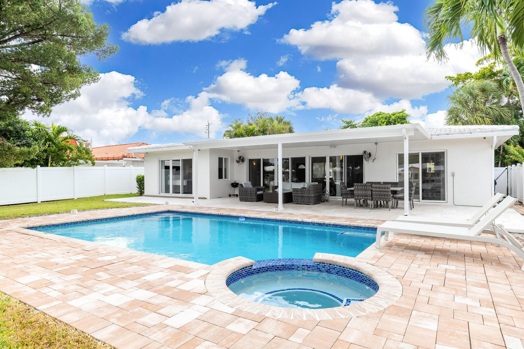 Bring your boat and experience the best of South Florida living in this stunning, furnished and renovated 3-bedroom, 3-bathroom home. With a beautiful pool, garage, and luxury finishes throughout, this home is truly turnkey. Enjoy peace of mind with a newer roof and impact windows, and fall in love with the brand-new gourmet kitchen, marble flooring. The home has spilt floor plan, recessed LED lighting, a travertine pool deck, a spacious paver circular driveway, and a master bedroom with a walk-in cedar closet. Open for short term ( 4-6 month) and annual rental. Ocean Access, 1 fixed bridge (Sunrise is 10Ft at High Tide). Located on a quiet, dead-end street east of US1, this property offers both serenity and convenience, just moments away from everything Fort Lauderdale has to offer.