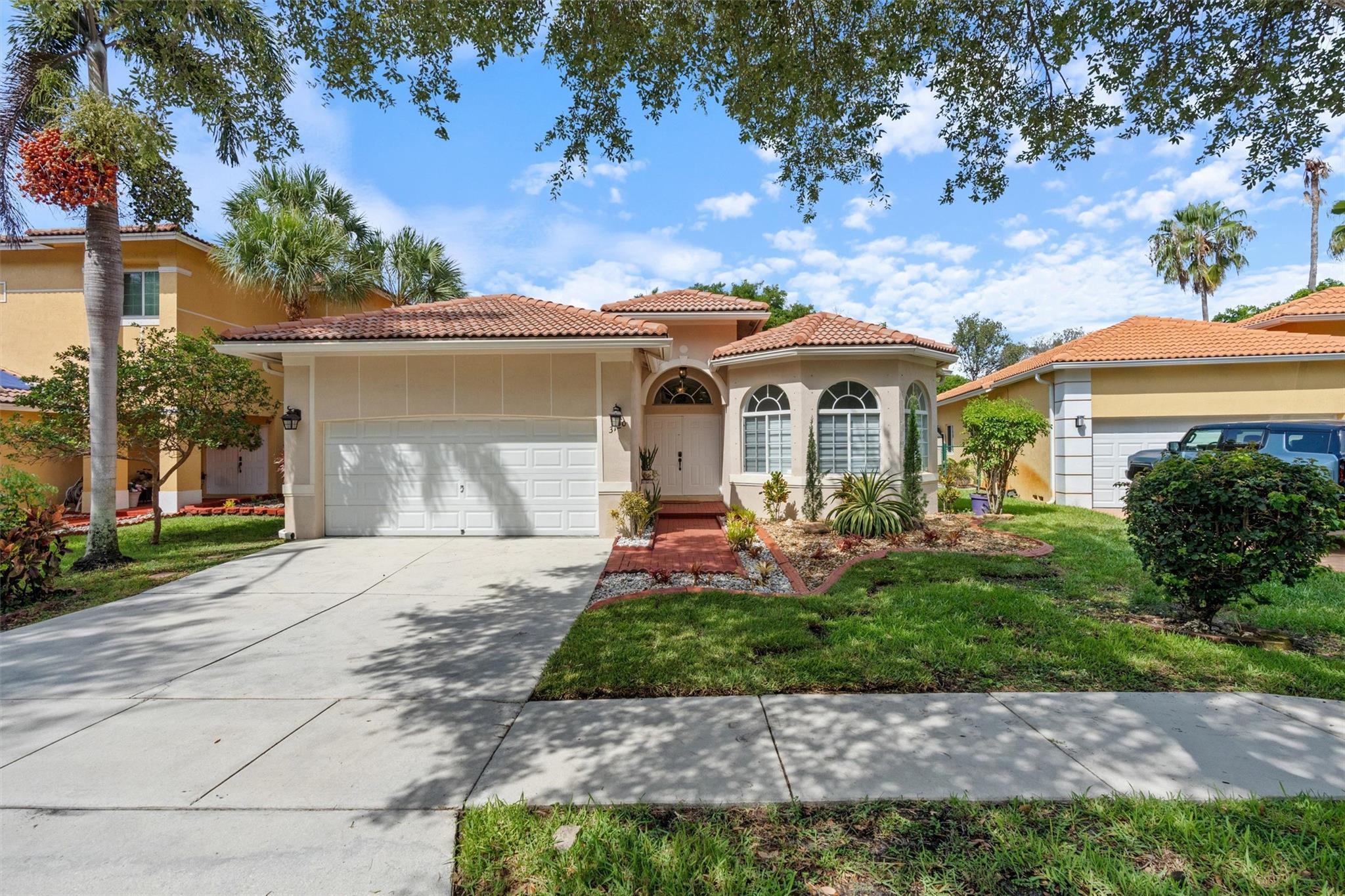 Experience lakefront living in this stunning 3 BD, 2 BA home in gated Catalina Bay subdivision. This open-concept gem features volume ceilings, crown molding, modern lighting, motorized shades and porcelain tile flooring. The renovated gourmet custom kitchen has stainless appliances, granite countertops and cherry wood cabinets, perfect for entertaining. Both bathrooms have new vanities and flooring. Relax on the covered patio with serene lake views. Enjoy peace of mind with hurricane shutters, a tankless water heater, and a 2015 AC. Monarch Lakes offers tennis and basketball courts, parks and playgrounds for only $160 per month HOA. Centrally located near A+ schools, I-75, turnpike, shopping, restaurants & Pembroke Gardens. This home is perfect for those who appreciate tranquil living.