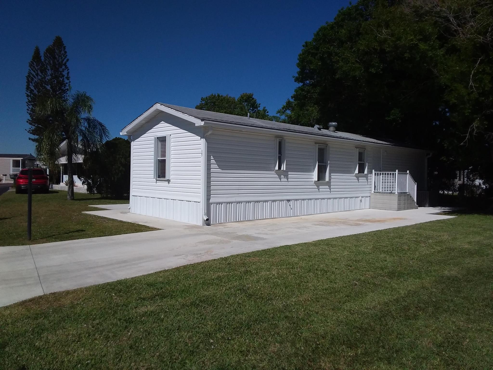 Beautifully updated 2/2 mobile home in Sandhill Shores 55+ Community. The interior boasts elegant porcelain tile flooring throughout, complementing the modern kitchen with granite countertops, a stylish subway tile backsplash, and including a dishwasher, stovetop and hood. Updated ensuite bathrooms include tiled showers and new vanities with an added bonus central vacuum. This home comes fully furnished and offers storage, including a workbench, washer, dryer, and an additional oven. Enjoy the spacious 26x11 screened porch, perfect for relaxing. Featuring accordion shutters, soffits, and gutters. This land-leased property covers lawn maintenance, sewer, and access to top-tier amenities, including a including a pool, fitness center, billiards, and clubhouse. Current monthly lot lease $775