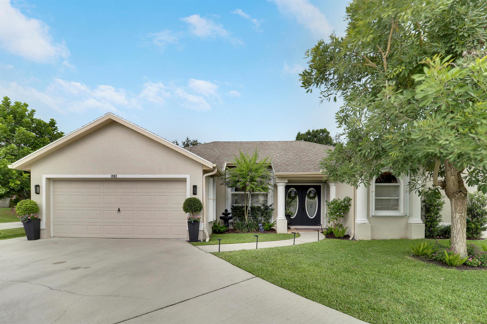 PRIDE OF OWNERSHIP gleams in this 3BR/2BA/2CG POOL HOME nestled on a beautifully landscaped large corner lot in established neighborhood! This CHARMING HOME has many lovely features including double entry doors w/ glass feature, spacious foyer, vaulted ceilings, wood-look tile flooring t/o, wood mouldings & ungraded light fixtures/fans! Kitchen has white cabinets, tiled backsplash, walk-in pantry, SS appliances, breakfast nook that opens to the family room w/ access to the pool & patio! Master Bedroom has views over the private backyard & spa-like ensuite with dual sinks, soaker tub & tiled shower! Two more bedrooms share a guest bath! Outdoor living is waiting to be enjoyed w/ screened/covered patio, heated salt water pool & open travertine paver patio! Fenced yard w/ tropical landscape!