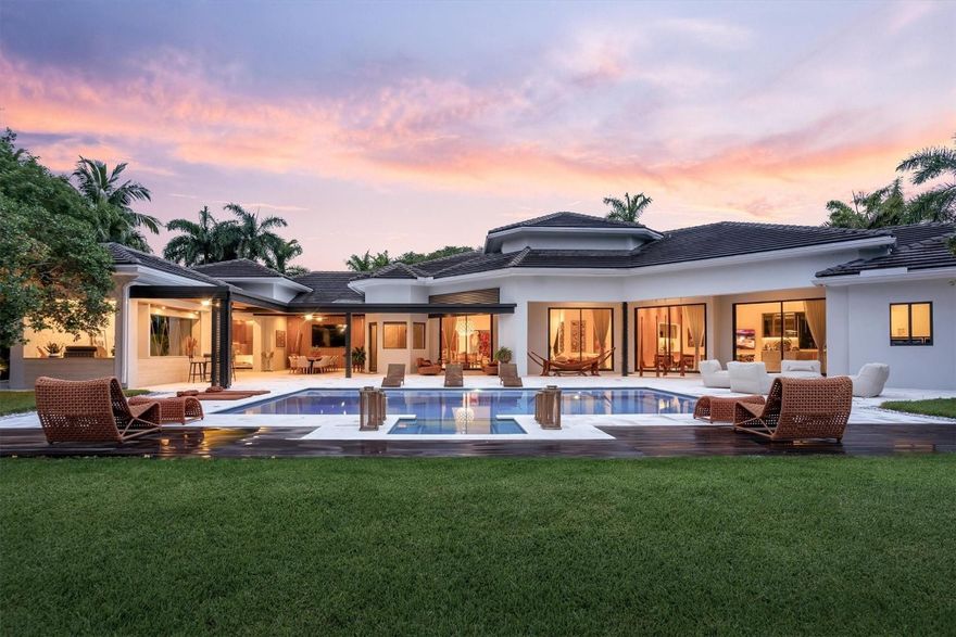 Step into what many will call the finest home on the market in Weston today, where photos simply cannot capture the scale, light, and emotion of this waterfront masterpiece. Set on a full acre in guard-gated Windmill Ranch Estates, this re-imagined estate delivers modern luxury at its highest level, with 7 private bedroom suites and 8.5 baths, and a primary retreat that feels like a five-star spa with a couture dressing room. Dramatic 18–22 ft ceilings. Outside, golden-hour lake views frame a true private resort with designer pool, spa, summer kitchen, and covered dining for unforgettable gatherings. Newer roof, full impact glass, gas service, circular drive, 3-car garage plus 2-car carport. This is not just a home—it’s a lifestyle that must be experienced in person to be believed. Live the Florida dream, sunlit days, balmy evenings, and effortless indoor-outdoor living—in a one-of-a-kind waterfront estate on a full acre in guard-gated Windmill Ranch Estates, Weston’s most exclusive enclave. This community is celebrated for its privacy, equestrian charm, and grand lake-dotted lots—an ultra-rare blend even within Weston. Step inside to soaring 18–22 ft ceilings and seamless flooring that glide from gallery-style living spaces to a custom chef’s kitchen, new bespoke cabinetry, luxe finishes, and light that pours in from walls of impact glass. Seven expansive bedrooms, all ensuite with walk-in closets, create true retreat spaces for family and guests. The primary suite elevates daily rituals with a boutique-caliber dressing room and a spa bath designed to delight.Outdoors is your private resort: sunset views over mirror-calm water, a designer pool and spa, covered dining, and a state-of-the-art summer kitchen for weekend gatherings. A 3-car garage plus 2-car carport, circular drive, 250-gallon gas tank, in-ground safe, newer roof, and full impact protection complete a home crafted for beauty and peace of mind.Why Weston? Because life is simply easier, and richer, here. The city consistently ranks among the best places to live in the U.S., thanks to its safety, parks, and overall quality of life, and was named a 2025–2026 U.S. News “Best Place to Live.”  You’re minutes from 245+ acres of parks and trails (think early pickleball, lakeside jogs, and shaded playgrounds), and a straight, ~22-mile hop to Fort Lauderdale’s beaches for sunrise walks or twilight dinners on the coast. Windmill Ranch Estates amplifies that lifestyle with rare horse-friendly amenities and serene, estate-scale parcels, privacy when you want it, community when you crave it. This is more than a residence. It’s a statement of timeless luxury and the ideal way to live Florida: light, water, space, and ease, beautifully connected.Schedule your private tour today and experience what makes this the most exquisite home on the Weston market, and the lifestyle you’ve been waiting for.