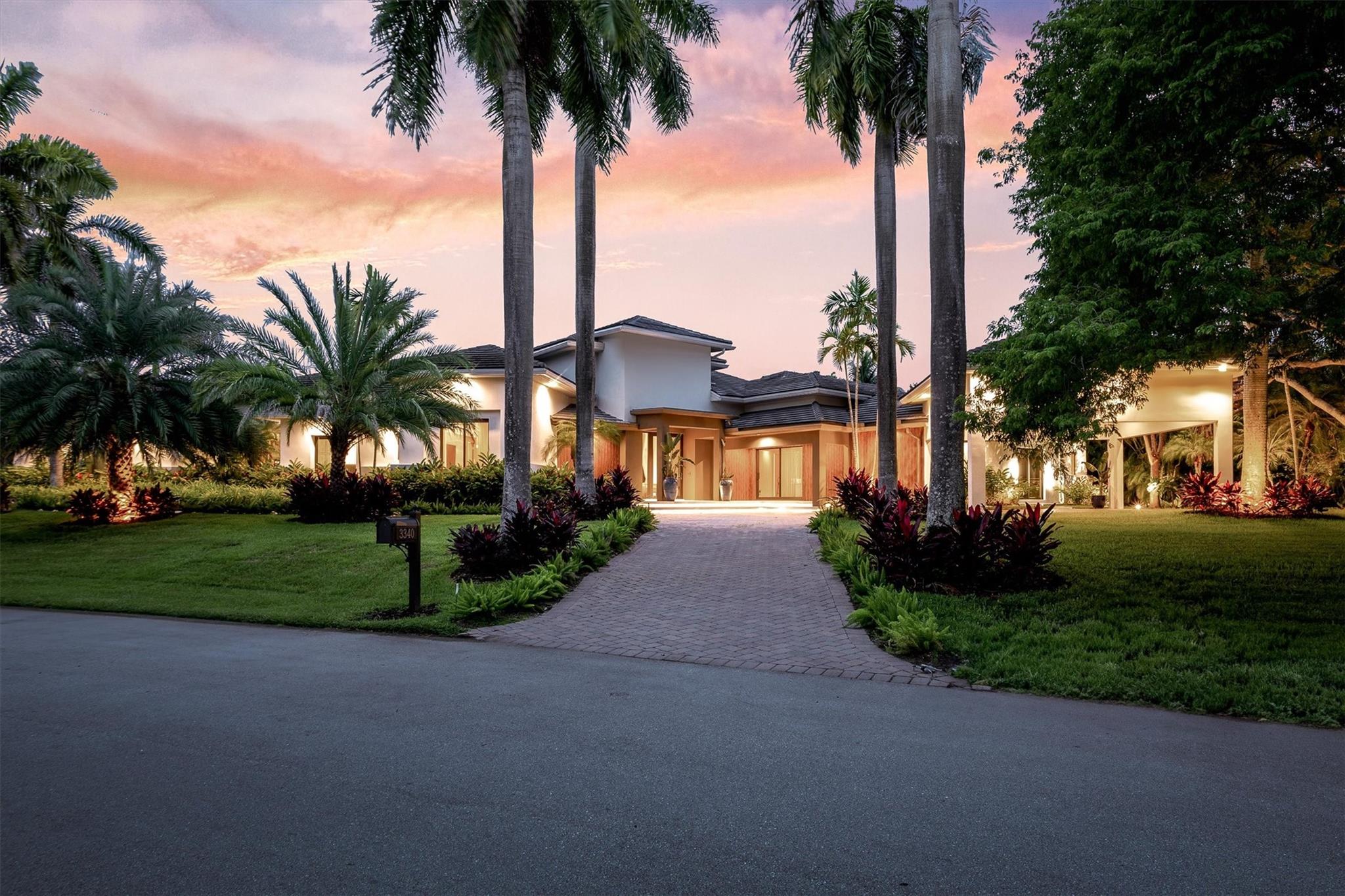 Presenting a top-to-bottom reconstruction: Weston’s foremost statement in modern luxury, an exquisite waterfront estate on a full acre within guard-gated Windmill Ranch Estates. A custom masterpiece, it offers 7 bedroom suites and 8.5 baths, each with walk-in closet; the primary retreat features a boutique-caliber dressing room and spa sanctuary. Soaring 18–22-ft ceilings, seamless flooring, and bespoke chef’s cabinetry showcase uncompromising craft. Peace of mind: newer roof, full impact glass, elevated finishes. Outdoors, a private resort, golden-hour lake vistas, designer pool/spa, summer kitchen, covered dining, and generous lounges. 3-car garage + 2-car carport, circular drive, gas service. Private tours by appointment. In Weston’s effortless Florida living. You must see it to Believe
