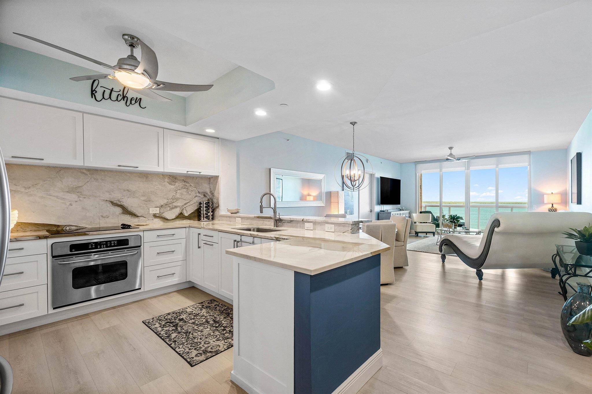 Stunning 2BR / 2.5 BA condo, impeccably updated & maintained! Remodeled kitchen w large slab granite counters & backsplash, custom cabinetry. Luxury vinyl floors throughout, private ensuite baths. His & her walk-in closets. Primary bath has jetted bath, frameless shower, double vanities, & water closet. Split floor plan, semi-private fob elevator access. Furniture negotiable. NEWLY RENOVATED rooftop oasis w/pool, spa, BBQ areas, tennis, pickleball, bocce. Clubhouse, billiard room & fitness center. 24 hr manned gate, temperature controlled storage, walk to Publix. Adjacent marina w/dry docks available, be on the ocean in minutes; no fixed bridges! Pet friendly.