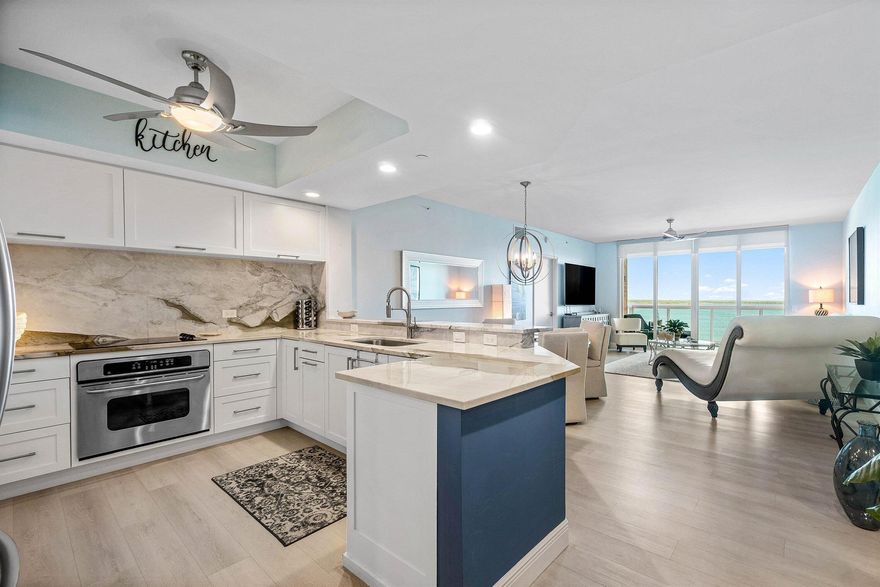 Stunning 2BR / 2.5 BA condo, impeccably updated & maintained! Remodeled kitchen w large slab granite counters & backsplash, custom cabinetry. Luxury vinyl floors throughout, private ensuite baths. His & her walk-in closets. Primary bath has jetted bath, frameless shower, double vanities, & water closet. Split floor plan, semi-private fob elevator access. Furniture negotiable. NEWLY RENOVATED rooftop oasis w/pool, spa, BBQ areas, tennis, pickleball, bocce. Clubhouse, billiard room & fitness center. 24 hr manned gate, temperature controlled storage, walk to Publix. Adjacent marina w/dry docks available, be on the ocean in minutes; no fixed bridges! Pet friendly.