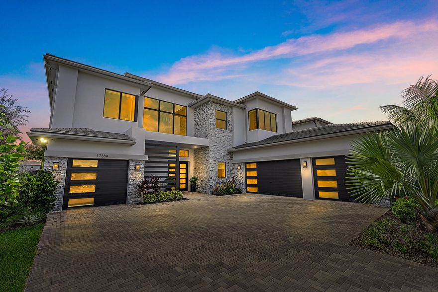 STUNNING TURNKEY FURNISHED ESTATE HOME (unfurnished option as well) is the epitome of luxury blending a contemporary yet warm & inviting vibe. Enjoy this grand & timeless home situated on a cul de sac and featuring tranquil lakefront views from virtually every angle. Featuring 5BD, 6.1 BA, 6,2000 LSF (8,000TSF), boasts a spacious 4 car garage, loft area, office, flex space & sauna. Upon entering, you are greeted with breathtaking soaring ceilings & serene water views. Designer finishes throughout & an open appealing floor plan make this home an entertainer's dream. Connect with family & friends with 2 living areas or enjoy your favorite movie in the theater room. The oversized office makes working from home a breeze and the perfect commute. Custom kitchen & Wolfe gas stove. The oversized sliders open to enter the ethereal zen patio designed for relaxing and rejuvenation featuring an oversized pool and spa. New HVACs, water filtration and impeccable internals throughout the home. 
This exclusive gem is located right in the prestigious Boca Bridges community. This elite community offers top tier amenities with a 27,000sf clubhouse, fitness center, racquet club, tennis, social events & gourmet restaurants within the comfort of your own neighborhood. Whether you're indulging in a gourmet meal at the club restaurant, rejuvenating with a massage, detoxing in the sauna, lounging poolside, or meeting up with friends, Boca Bridges ensures you'll enjoy a five-star lifestyle that's truly second to none.
This ultra luxury home encompasses all facets of Florida Living from quiet cul de sac location, premium design & finishes to the grand scale entertaining space, all while being in the heart of this renowned locality.