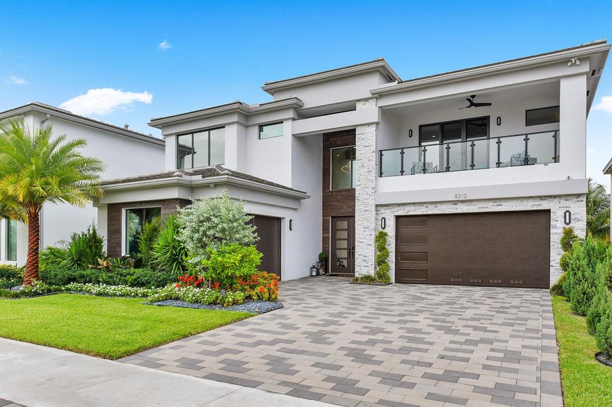 Discover the epitome of luxury living in this custom-built Lotus residence with a long lake view! This Lotus Sumatra Model is completely upgraded offering spacious and elegant living areas, designed for both comfort, yet exuding sophistication. From the split three-car garage, you'll enter the grand foyer, which features a two-story space, complete with modern chandeliers, and a piano. Behind the crystalia doors, a completely built out office is a stylish retreat. The living room and kitchen overlook the sparkling heated pool and spa, with deep views of the lake, and tropical landscaping.  The first-floor primary suite features custom window treatments, a spa inspired bath with jetted shower and floating tub. Upstairs, you'll find four additional bedrooms, each with a private bath