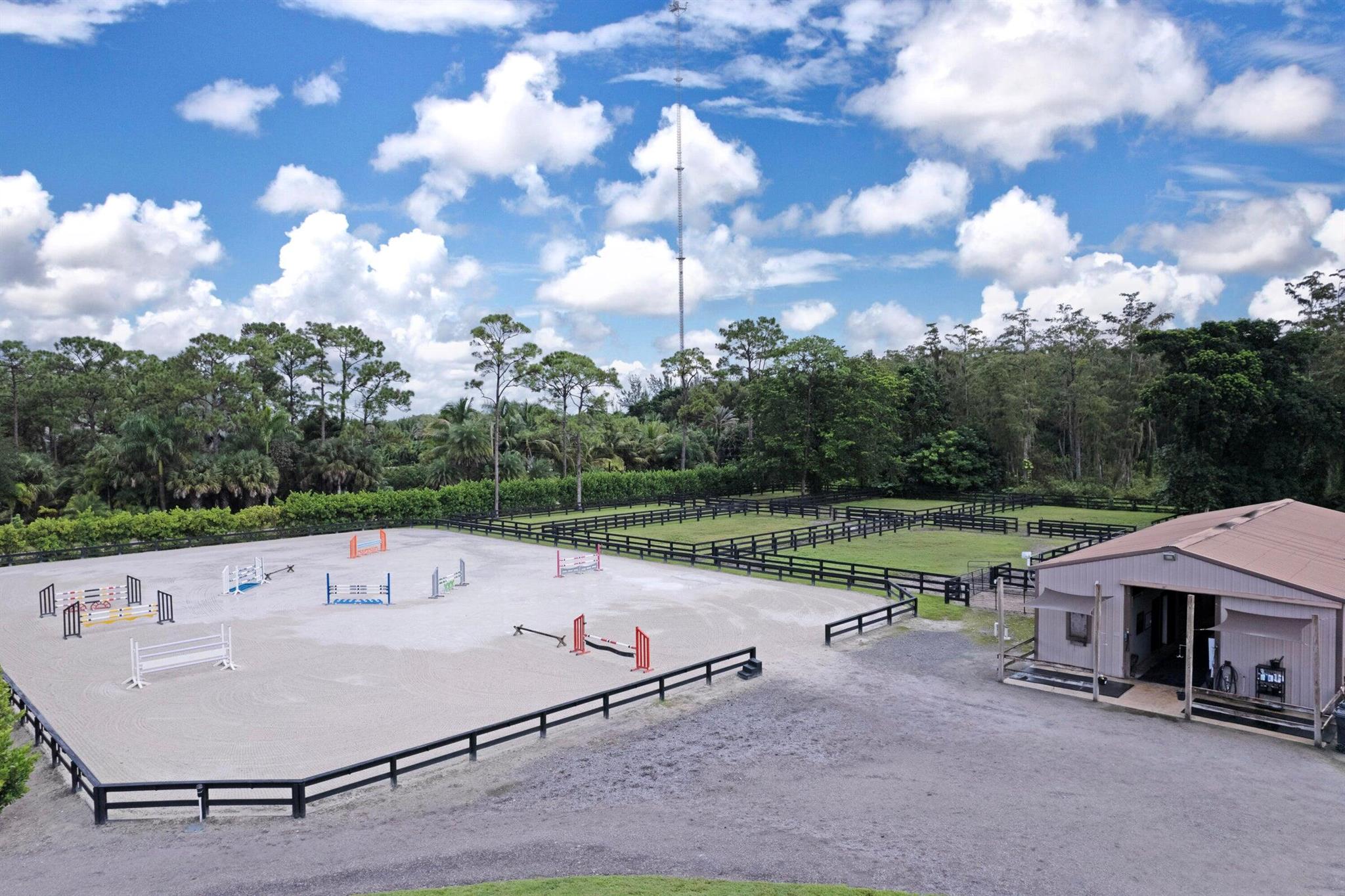 AVAILABLE OFF SEASON & 2025-2026 SEASON !!!!This equestrian facility offers everything you need. 20 mins to WEF! Private facility offering 5 acres 9 stalls total ( 6 stall center isle 10x16 with 3 walk outs) 3 stalls shed row style are 12x12. Large tack/lounge room, grooms apt in barn with full bath & laundry. Trainers housing also available in detached building. 6 oversized grassy paddocks, full jump course provided, 175x115 irrigated arena made up of a sand/fiber mix, round pen for lounging, fly spray system, 3 wash racks, access to cameras in each stall, tractor & drag and so much more! Do not miss this opportunity to spend your time at this farm!