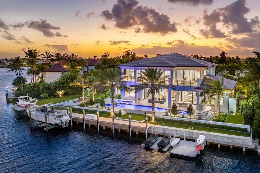 Situated on over one-half of an acre with 178 feet of waterfrontage, this Point Manalapan estate checks all the boxes for luxury living. Newly built and offered furnished, this noteworthy property has been enhanced by the Seller to create a masterpiece. The open floor plan offers extensive water views, thoughtful room separation and abundant space. Amenities include four-car garage; 162-bottle wine room; kitchen with two islands; first floor primary wing; gym; club room with bar; loft; and four guest suites. Enjoy resort-style pool with spa; outdoor loggia and summer kitchen; fire pit; large balcony; and expansive manicured grounds. Boaters will appreciate the 75-foot dock and duel boat-lifts and nearby ocean access.