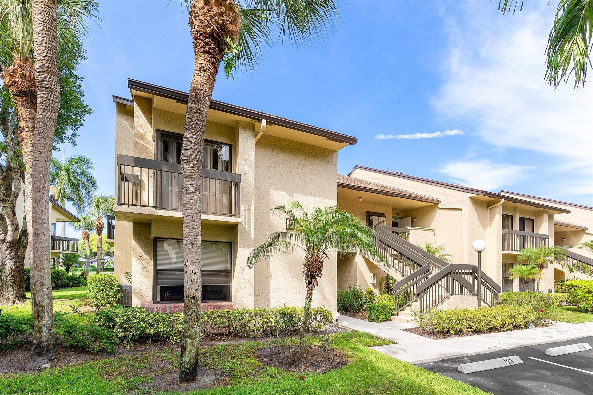 Enjoy luxury living in this well-maintained end unit with breathtaking panoramic views of the lake, fountain, and golf course. This 2BR/2BA plus den residence offers a bright, open layout with a spacious eat-in kitchen featuring newer appliances, a screened-in porch, and tranquil water views from nearly every room. Located in a prestigious gated community offering an 18-hole executive golf course, 5 Har-Tru tennis courts, 2 resort-style pools, and a newly renovated clubhouse with a cafe, fitness center, card room, library, entertainment, and year-round social activities all without high equity membership fees.Manned gate for peace of mind.Minutes to world-class beaches, fine dining, shopping, and major highways. An exceptional opportunity to enjoy the country club lifestyle w/o high fees