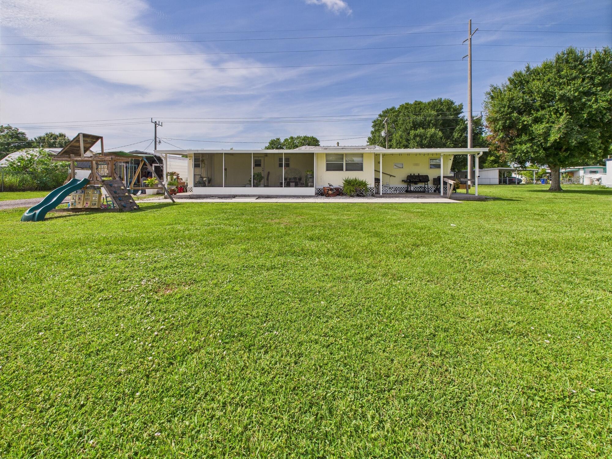 Full of Southern charm, this 2BD/2BA home in Kissimmee River Estates is a unique find just 1.5 miles from a boat ramp with direct access to the Kissimmee River and Lake Okeechobee. Originally a single-wide mobile home, it features thoughtful additions altogether featuring a spacious master suite with a large walk-in closet that could double as a nursery, a bright living area, and three outdoor spaces--a screened front porch, an open front porch perfect for grilling or golf cart parking, and a wood deck off the kitchen for entertaining. There's also an attached storage room, a shed with the second bath, and alley access for easy trailer parking. No HOA, low taxes, and a 3 yr old metal roof. Cash only.