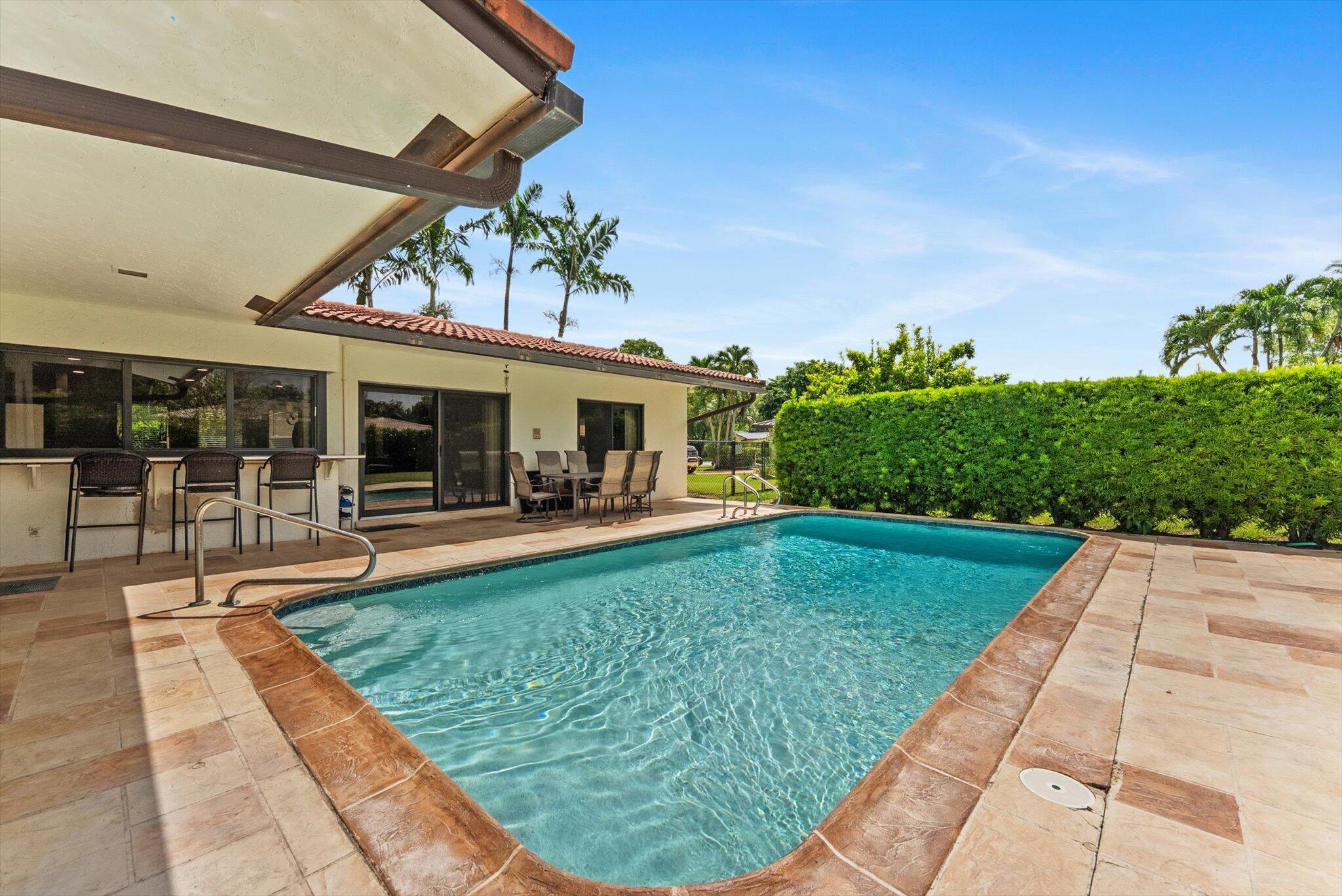 In the Heart of Coral Springs large Home with a new kitchen, new quartz, new floors, full impact windows, and a remodeled pool! This 2512 total sqft home is in the center of Coral Springs within minutes of everything. A huge 3/2 home with a 2 car garage and large pool, has plenty of room for your family. Fully fenced landscaped yard with beautiful paver driveway, lush vegetation, and several fruit trees including Mango, Avocado, Soursop, Sweetsop, Star Fruit, Jackfruit, Sapodilla. Enjoy your large island kitchen overlooking the pool and patio along with a spacious dining room and family room make this a perfect family home! And all of this in the beautiful neighborhood of Maplewood! PRICED TO SELL!