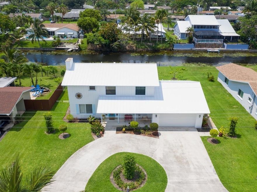 Wonderful remodeled large 2-story waterfront home in desirable Golfview Harbour in Boynton Beach, FL.  Plenty of parking. Can install up to a 250 Square Foot Dock. Close proximity to everything Boynton Beach and Delray Beach have to offer.  Walking distance to Bethesda Hospital.  Four bedrooms, 2 baths on the 2nd floor.  Master suite features walk-in closet and awesome outdoor balcony overlooking natural water views.  Travertine flooring in the living room, dining room, kitchen, den/office, laundry room, half bath & pantry room.  50 year metal roof was installed in 2017.  A/C - 2016.  Impact glass windows and hurricane garage door for your added safety.  Spacious rear screened-in porch is perfect for entertaining.  Large 19 X 19 garage for your toys.  No HOA restrictions! Caloosa Park is walking/biking distance from this home with lake, playground, sports fields, picnic facilities, walking paths and more.