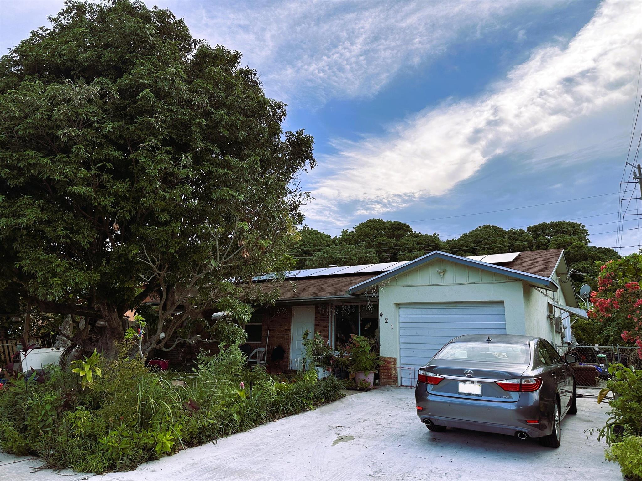 Situated on the sought-after west side of I-95, this well-maintained 3-bedroom, 2-bathroom home offers a smart blend of comfort, efficiency, and convenience. With solar panels and partially hurricane-impact windows, the property is both energy-efficient and storm-ready ideal for long-term savings and peace of mind. The interior features a functional layout with spacious bedrooms, a bright, open living area. The kitchen flows seamlessly into the dining and living spaces, making it a great setup for both everyday living and rental potential. Enjoy quick access to I-95 and the Florida Turnpike, placing dining, and major commuter routes within easy reach. No HOA means no rental restrictions, added flexibility, and lower overhead making this a perfect opportunity for investors or homeowners lo