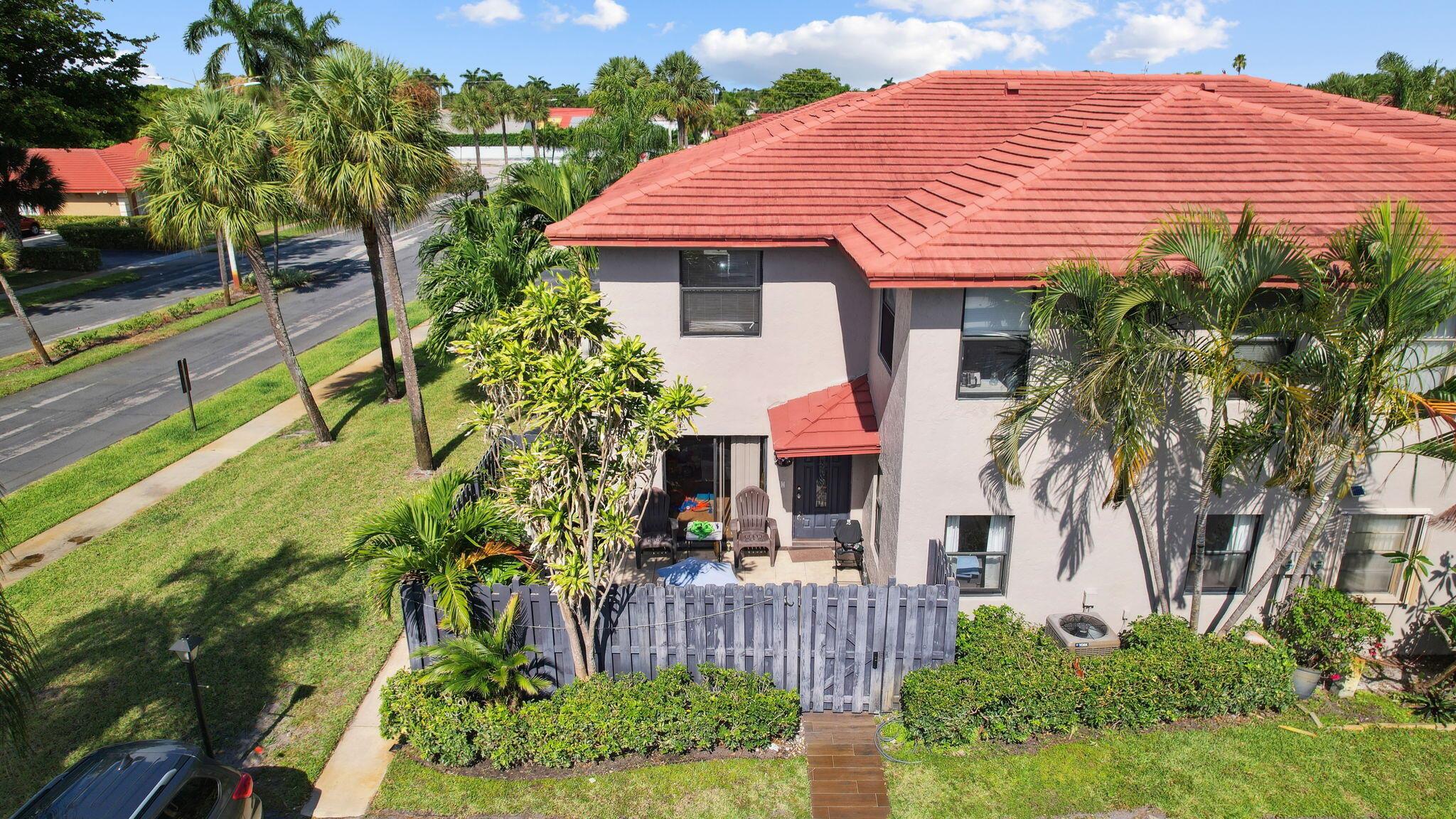 Step into a blend of comfort and convenience with this stunningly renovated 3 bedrooms, 3 bathrooms townhouse nestled in the vibrant heart of Boynton Beach. This enchanting home features a newer roof and a spacious, fenced courtyard with a concrete pad and a plantable area, perfect for those who love gardening or have pets. Inside, the ground floor greets you with large tile flooring and an expansive layout that includes a huge living room, dining area, and a cozy family space. The kitchen is a culinary dream with ample counter space, pristine granite countertops, and sleek white shaker cabinets, ideal for preparing gourmet meals and entertaining guests. The convenience continues with a utility room, a full bathroom, and clever under-stairs storage solutions