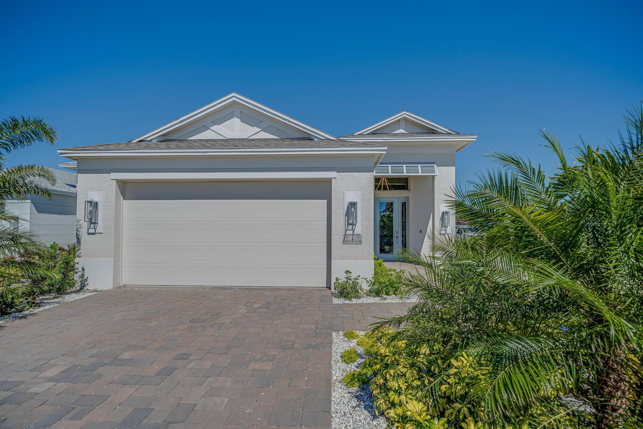This gorgeous 2-bedroom, den, 2-bath home, is on a fantastic oversized homesite with partial lake views. The Beacon plan features an open concept layout with coffered ceiling in the great room and master bedroom creating spacious, and elegant, living spaces, with crown molding. The Falls neighborhood offers community walkways with a bridge to an island, as well as a community pool. Plus, included with the purchase of this home, GHO will cover the initial fee for Sports membership at the Grand Harbor Golf & Beach Club.