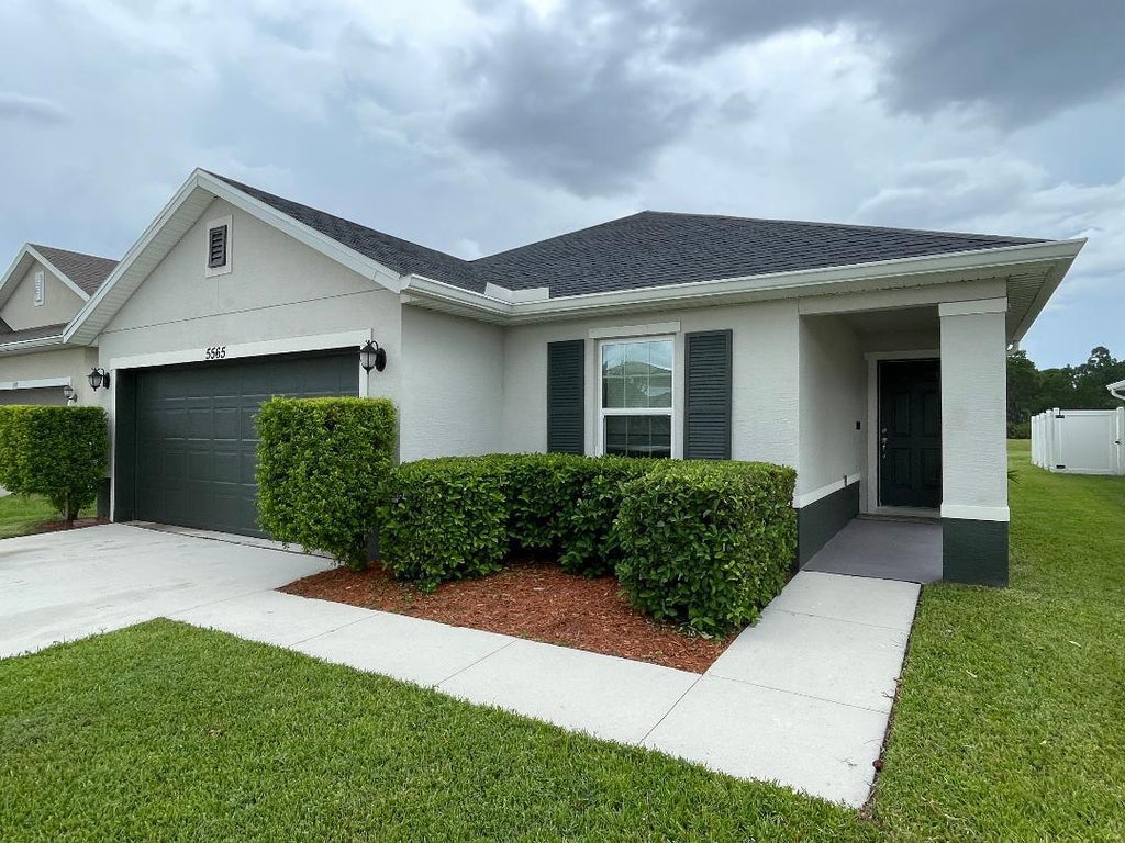 Photo of 5565 NW Pine Trail Circle, Port Saint Lucie, FL 34983 (MLS # B26059092)