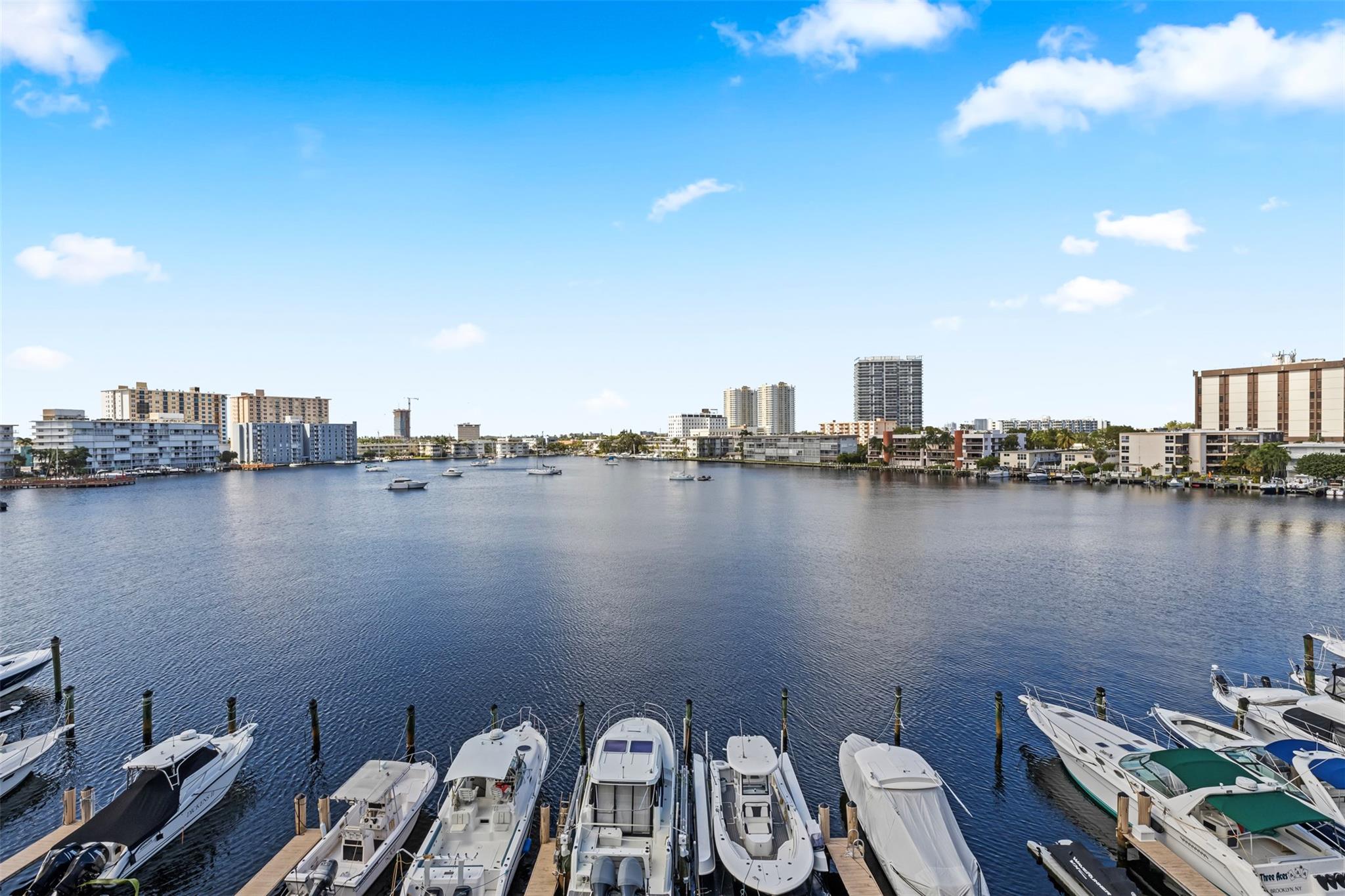 Enjoy peaceful mornings with panoramic views of Golden Isles Lake from your oversized wraparound balcony. This updated 2BD/2BA Hallandale Beach condo features an upgraded kitchen, modern flooring, and a remodeled primary bath. Water views from the living, dining, and bedroom create a serene retreat. The building offers a pool, community room, marina access (manageable waitlist), and laundry shared by just 4 units per floor. Newer roof, maintained A/C, and extra storage add value. Walk to the beach, Publix, shops, and dining. No rentals or pets allowed—offering true privacy, a peaceful community feel, and the chance to enjoy your home without the noise or constant turnover of vacation traffic.