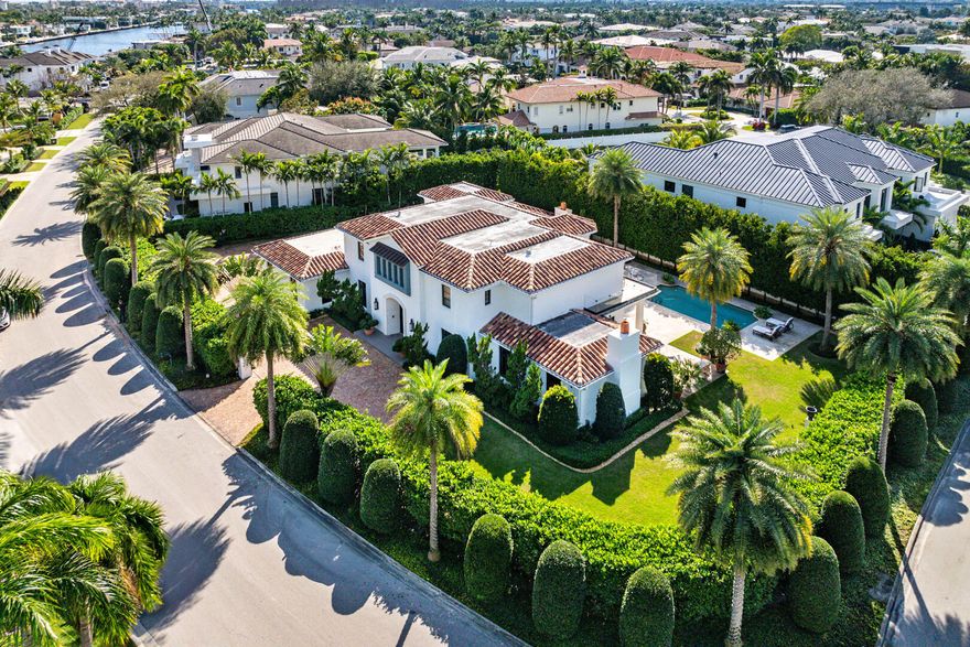 A rare offering on a coveted corner double lot, this Palm Beach-inspired estate blends timeless architectural beauty with modern ease across a sprawling, gated setting. Behind private walls, a brick motor court welcomes you home to five generously appointed bedroom suites, a dedicated office, and a separate first-floor guest wing complete with a yoga room and cabana bath—ideal for hosting with privacy and comfort. The resort-style backyard is a true retreat, designed for year-round enjoyment with a heated pool, lush family-friendly lawn, and a covered loggia featuring a fireplace, built-in BBQ, and wood-fired pizza oven—all enhanced by retractable screens for effortless indoor-outdoor living. At the heart of the home, a state-of-the-art kitchen showcases top-tier appliances. It flows seamlessly into light-filled living spaces with warm organic finishes and impeccable detailing. Upstairs, the owner's suite offers a serene escape with a private balcony, spa-like bath, and boutique-style closets.

Additional features include a 4-car garage with a golf cart bay, a permanent generator, tankless water heaters, and natural gas. Every element of this residence is curated thoughtfully for discerning buyers seeking refined living and exceptional space in a premier location.