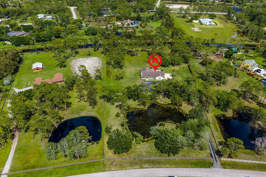 Located within the gated Homeland community, this beautiful single family home offers a comfortable blend of style and everyday living on nearly five private acres. With 4 bedrooms and 3.5 bathrooms, the home comes fully furnished and ready for a seamless move in. Inside, you will find a bright, open layout filled with natural light and spacious living areas that feel both inviting and refined. The easy flow of the home makes it perfect for relaxing or entertaining without feeling overdone. The expansive property provides privacy and room to enjoy the outdoors, making it especially appealing for those who appreciate the equestrian lifestyle or simply want extra space.  All of this is set in a prime location close to top rated schools, shopping centers, dining, and daily conveniences, offering a balance of peaceful living and accessibility.