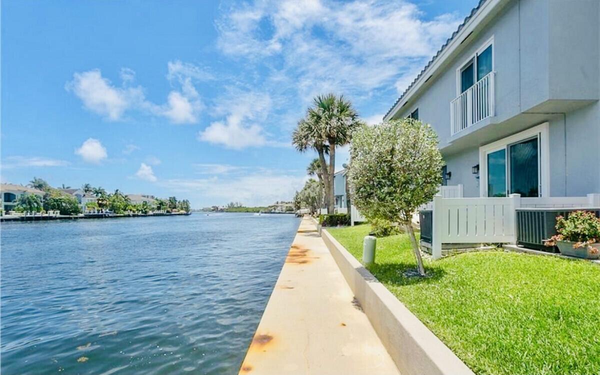 One of the most tastefully upgraded, modern design homes, at the BEST PRICE you will find in the beautiful waterfront community of Boca Quay. This highly desirable neighborhood in east Boca Raton is located on the intercostal for residents to enjoy the water, and only a few minutes from the beach. Fully furnished with quality furniture. This elegantly designed town home shines new upgrades, mint condition furniture, and fresh paint throughout. Beautiful travertine tile throughout the residence, crown molding on ceilings, and in-unit washer/dryer. Cozy fully fenced in back patio with grill. Two very large, newer flat screen televisions already mounted, ready for your entertainment (approximately 75'' tv in living room & 56'' tv in one bedroom).