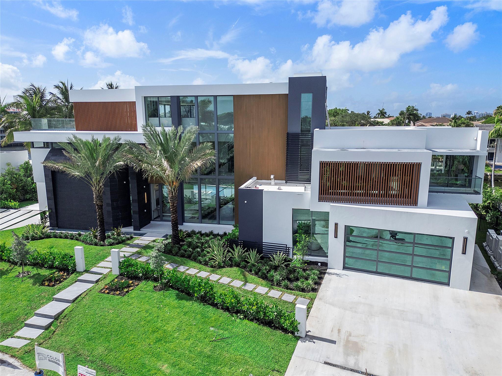 Welcome to Palazzo Corallino! This Incredible 3-Story Modern Resort Sanctuary is Perfectly Designed to Inspire the Highest Level of Luxury Waterfront Living to Ever be Delivered in Ft Lauderdale's Coral Ridge Community. Exceptionally Positioned on a Prime Oversized Lot, Southeast Exposure, 1 off the point, on 153 feet of waterfront in a no wake zone. This Supreme Zen Compound offers the Ultimate Indoor/Outdoor Living Experience Sprawling 12,976 sq ft of total living area, hosting 6 Bedrooms, 8 Baths, Club Room, Home Gym, Office, Spa w/Sauna/Cold Plunge, 3rd Floor Media Entertainment Room w/ Roof Top Sky Lounge, Chef Kitchen, Butler Kitchen, Private Crew/Staff Quarters on 1st Floor, Flow Through 4 Car Garage. Expansive Backyard Resort with Enormous Pool, Swim up Dock Bar, Summer Kitchen!