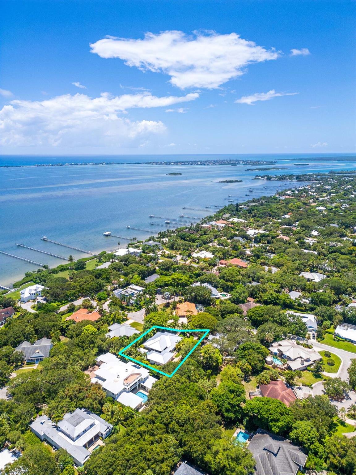 First Time on Market! So rare, that you will not find another like it in Sewall's Point. Where timeless design meets the natural beauty of Florida's treasured barrier island. Nestled in the coastal town of Sewall's Point, this exceptional custom estate offers a rare combination of elegance, craftsmanship, and thoughtful design. Situated on a quiet street beneath a canopy of native trees, the property includes a charming 1-bedroom, 1-bath guest house and a meticulously crafted main residence that radiates warmth, livability, and architectural detail.The main home features a spacious primary suite with its own sitting room, private office, and dual walk-in closets. Two additional bedrooms share a Jack and Jill bath, with one currently serving as a second office--offering