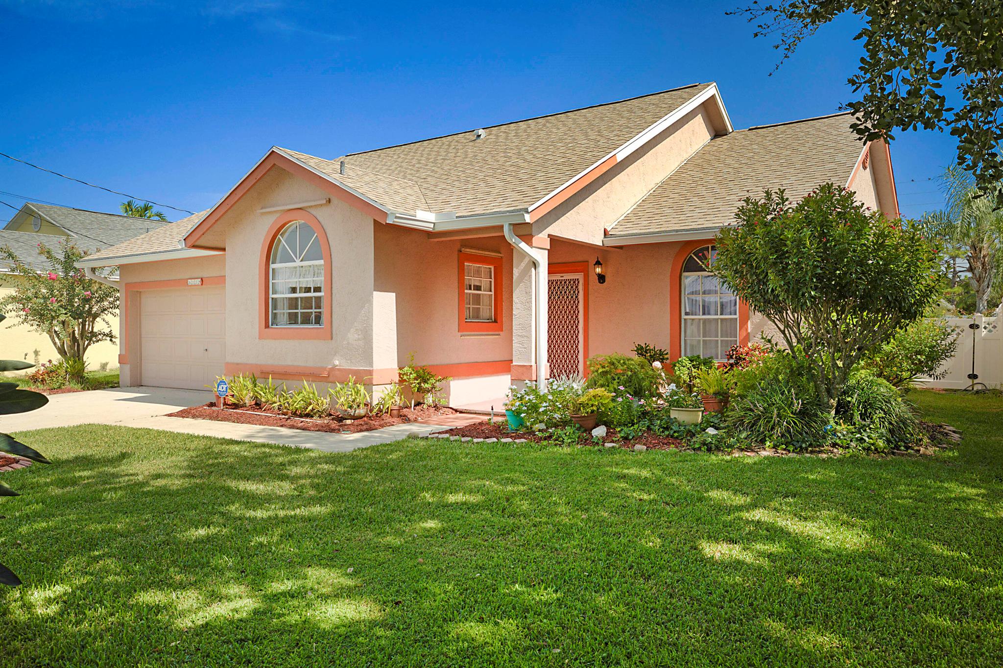 This three bedrooms, two bath, two car garage CBS constructed home in the sought after community of North Palm Beach Heights was lovingly maintained by the original owner and is ready for your personal touches. Features include the newer roof (Dec 2024), HWH 2020, A/C 2017 with new evaporator coil installed in 2025, beautifully landscaped fully fenced back yard with a 12' x 24' wood deck patio, cathedral ceilings in the living area and primary bedroom. No HOA!