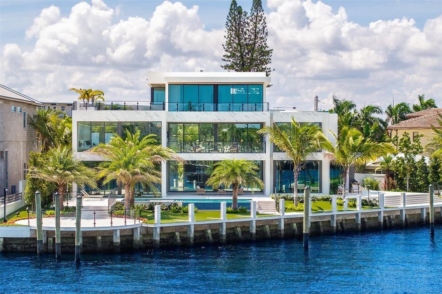 This 3 story custom masterpiece has it all. Passing through the oversized pivot door, you are greeted with double high ceilings & oversized glass sliders offering a picturesque long-water view. The homes design makes the most of the lot, providing breathtaking views from almost every space across all 3 floors. An elevator provides easy access & your garage has ceiling height to allow for a lift (up to 6 cars). A Control 4 system manages your full spectrum Color-Beam lights & concert quality sound. Your concrete dock offers 3 Power Pedestals & 140'+ straight to accommodate your yacht(s). A summer kitchen complete with smoker, ice maker, & fridge right outside your kitchen. A full-home Generac Solar system w/ 3 power banks provides further peace of mind. Home is wired for Lutron Shades.