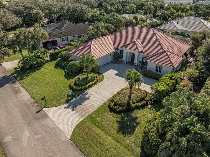 Coastal 3000+ sq ft.  CBS home.   3BR 3.5 bath in gated Sandpointe, w/deeded beach access & river access!  Luxurious 7 rm residence w/ gracious mahogany double door entrance, foyer, Bonus rm: den/office, 10+ ft ceilings, crown moldings, stone center island kitchen with breakfast nook & fam room w/wood burning fireplace.  Large living rm w/sliders to lanai w/heated salt water pool, and outdoor living area. A formal dining room to host dinner parties.  Split BR plan, primary en suite with 2 large walk ins, full bath with soaker tub, sep shower & dual vanities.  2 large bedrooms w/2 other tiled full baths.  2 paver ladenside garden/BBQ areas. Separate laundry room w/ sink, upgraded appliances, impact windows, newer central air, paver driveway & pool patio, surround sound, central vacuum