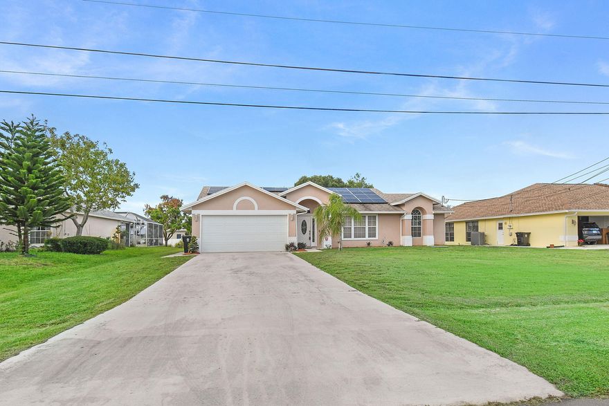 Welcome to Southbend living! This beautifully maintained 3BR/2BA canal-front pool home with a 2-car garage offers the perfect blend of comfort, space, and Florida lifestyle. Featuring vaulted ceilings, abundant natural light, tile flooring throughout the main living areas, and a spacious split floor plan, this home is ideal for everyday living and entertaining. The kitchen features granite countertops, wood cabinetry, and a pass-thru window to the patio. Enjoy your screened-in pool and patio overlooking peaceful canal views. Additional highlights include a 2021 roof, 2020 A/C, 2023 water heater, RainSoft water treatment system, and solar panels. Conveniently located near the C-24 Canal boat ramp, parks, Tradition, shopping, dining, I-95, and the Florida Turnpike.