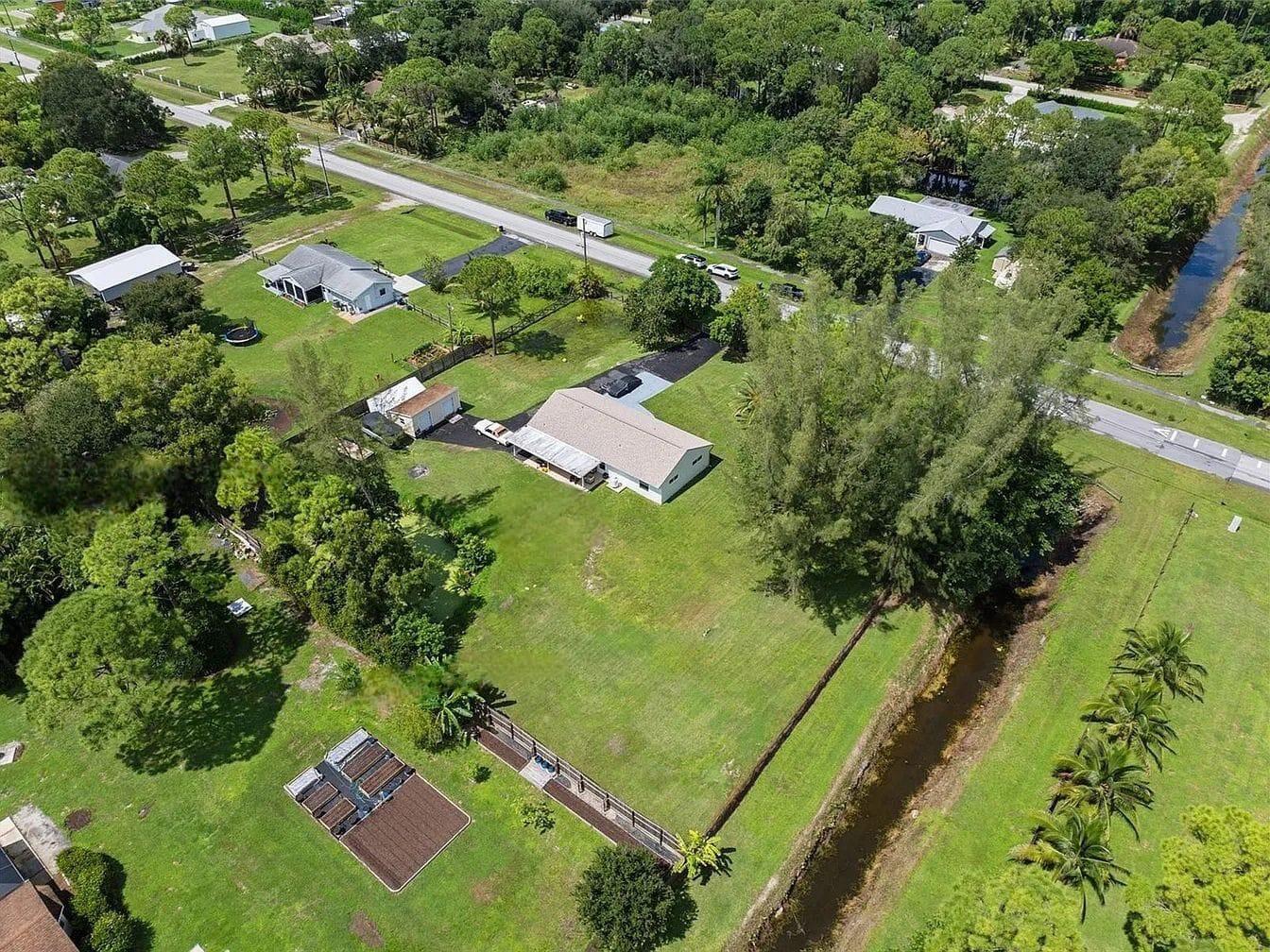 Experience the perfect blend of space and privacy on this 1.37-acre lot in the desirable Acreage subdivision of Loxahatchee! This remodeled home offers plenty of room for outdoor activities, gardening, or even horses. With a north-facing front, generous yard, and proximity to top-rated schools, it's perfect for equestrian enthusiasts or anyone seeking a country lifestyle with convenience nearby. Don't wait and schedule a showing today!