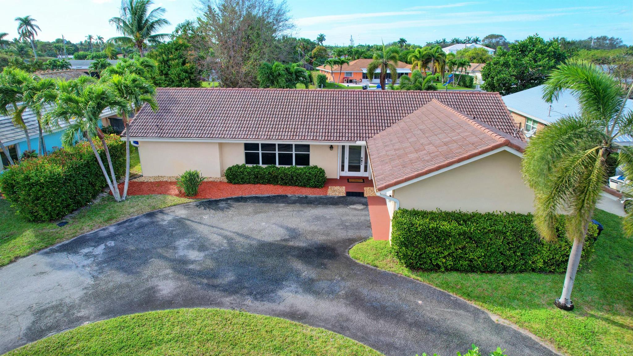 Welcome to Paradise ! South Florida living at it's finest, on the water and close to the beach. 4-bed, 2-bath, 2-car garage. Over 3,000 sq. ft. total. All tile, screened in patio, spacious backyard. Centrally located, close to I95, Lake Worth Beach, 10-mins to downtown West Palm Beach. Boat lift, Dock, Seawall, accommodates up to a 30ft boat.