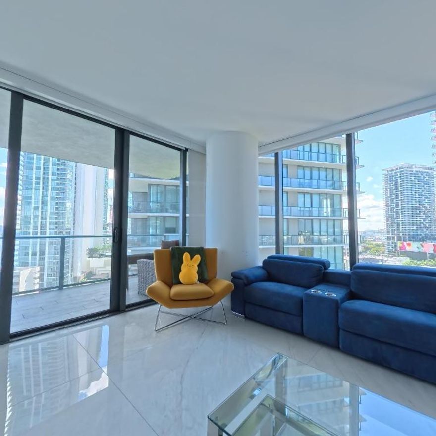 Corner residence featuring 3 bedrooms, 3.5 baths with sweeping, unobstructed water views. Fully finished with sleek porcelain flooring throughout and elevated with premium, contemporary finishes. Enjoy an open-concept living space and a chef-caliber kitchen equipped with Bosch and Sub-Zero appliances.

Residents have access to unmatched, resort-style amenities including a boutique bowling alley, wine cellar and tasting lounge, billiards room, cigar lounge with private humidors, kids' multimedia game room, and a full tennis center with two lighted courts. Outdoor perks include grilling stations, a putting green, a bayfront park, marina access, and so much more.