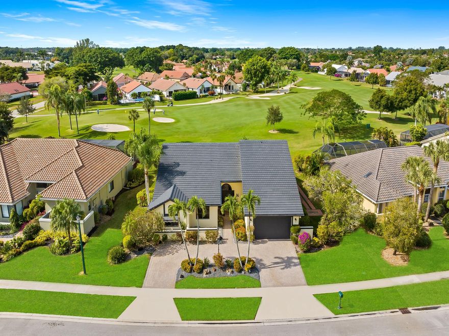 Boca Woods Country Club. Move in ready home with a NEW ROOF May 2024. Step inside and be greeted by an abundance of natural light illuminating the bright spacious open floor plan w/volume ceilings. Property features spilt bedroom plan with three bedrooms, three and one half baths, circular driveway, two car plus golf cart garage. Kitchen is a chef's delight with plenty of counter & cabinet space and island with counter seating. Oversized travertine patio with a sparkling salt water pool & spa over looks an expansive panoramic view of the lakes course creating a serene backdrop for outdoor living at its finest. BWCC offers 2 golf courses, pickleball, tennis, fine and casual dining, fitness center, spa, game room and much more. Mandatory membership $ 120,000, see attached yearly fees & dues