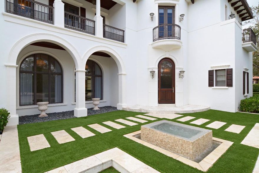 Elegant meets Exquisite! This custom residence situated on 1 acre has everything. Offering golf and water views, marble floors throughout the entire house,elevator,gas gourmet kitchen, outdoor fireplace, 1st and 2nd floor wet bars. Sweeping water and golf views from the backyard and 2nd floor balconies.  Family room also as a game room including pool table.  Large covered patio area with working fireplace.  Private dining area plus a large wet bar make this residence the perfect home to entertain.  The library is truly a work of art offering views of the pool and private grounds.  Separate dog run with door on the east side makes this a perfect place for 10X20 master bath, large custom closets 3 plus garages, and a porte-cochère.  Decorator furniture negotiable.