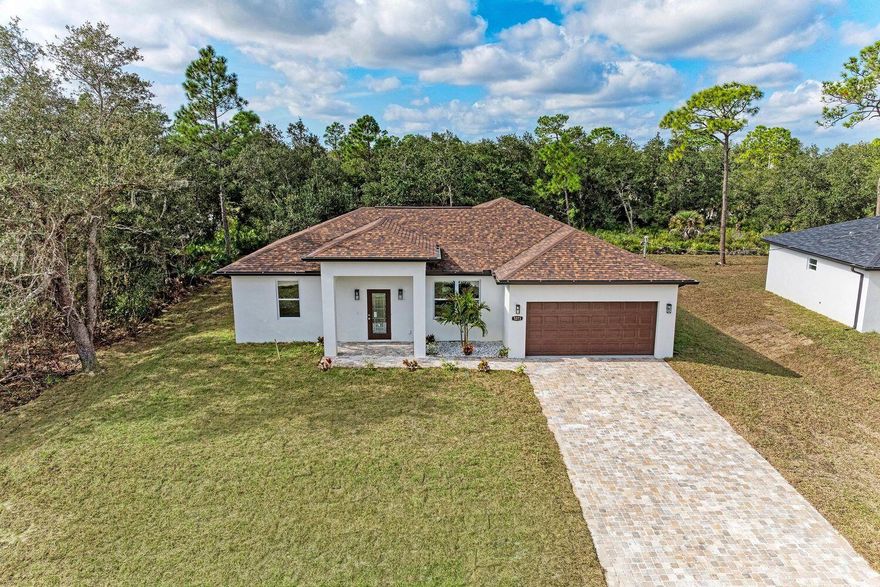 PREFERRED LENDER OFFERING: Up to a 1% Reduced INTRODUCTORY INTEREST RATE!  BRAND NEW CONSTRUCTION. With  elevated finishes, Hurricane Windows and doors,  the Caputo Road Collection delivers! Get an exclusive first look at brand-new, high-quality homes crafted with attention to detail that surpasses what buyers typically see at this price point. In fact, these homes deliver on exceptional construction, thoughtful design, and upgrades that truly elevate the living experience. Step inside and you're immediately welcomed by 9-foot ceilings enhanced with tray-lighted and coffered ceiling details in both the living room and primary suite -- a feature normally reserved for much higher-priced builds. With ~$60,000 in upgrades this home delivers value and quality! Natural light fills the space through impact windows, and impact doors, adding safety, energy efficiency, and peace of mind. The kitchen is a standout, offering a full stainless steel appliance package, trash compactor, 42-inch upper cabinets with crown molding, a large kitchen island, with granite counters and windowsills, along with recessed lighting that sets a refined tone. The home is fully tiled throughout the home, and paired with upgraded crown molding and trim for a clean, cohesive, elevated look. Enjoy Florida living at its finest with a screened-in lanai, perfect for relaxing or entertaining year-round. Exterior upgrades include a fully paved driveway and walkway, as well as an automatic garage door opener included at delivery. These thoughtful touches truly make the home move-in ready. It's neighbor home, 5265, is also an available listings for sale. Premium Features Included: Full Kitchen Stainless Steel Appliance Package 9-Foot Ceilings in Living & Dining Tray-Lighted Coffered Ceilings (Living Room & Primary Suite) FULL Impact / Hurricane Proof Windows FULL Impact / Hurricane Proof Front and Garage Door Screened-In Lanai 42" Kitchen Cabinets w/ Crown Molding Kitchen Island with Granite Countertops and Windowsills Fully Paved Driveway & Walkway Recessed Lighting Automatic Garage Door Opener Fully Tiled Floors Throughout Upgraded Molding & Trim Package With quality construction, designer finishes, and an inviting open floor plan, the Caputo Road Collection offers immediate comfort and long-term value in one of North Port's most in-demand neighborhoods. This home offers about $60,000 in upgraded amenities. For the introductory Interest, terms and Conditions Apply. Note: Buyer responsible to verify information provided.