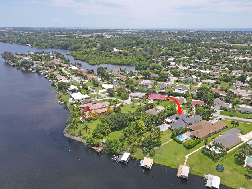 Jet Skis and all furnishings included with this stunning vacation home on Lake Osborne. Ideal for entertaining, short term seasonal rental. Private boat dock, 3 wave runner lifts, paddle boards, foosball, ping pong, gym, volleyball, game room, Sonos system, TV, and more. Fully stocked kitchen with quartzite counters and large island. Exquisite marble and Brazilian cherry hardwood floors throughout. 2 offices, 1 may be used as a 6th bedroom. Upstairs private guest suite with balcony view of lake and sunsets. Close to airports, beaches, High Ridge Country Club, Palm Beach, Manalapan, WPB, equestrian events, & entertainment unique to south Florida. Meticulously clean and maintained. Decorated with attention to details. Furnishings, linens, decor like new. No HOA. No rental restrictions.