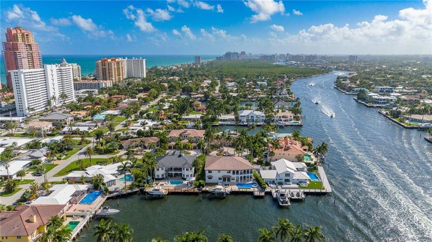 Live a luxurious lifestyle in this modernized Mediterranean estate located in Dolphin Isles, just off Fort Lauderdale's beach front avenue of Lauderdale Beach.  Sited on a 10,461 square foot lot with 100 ft of water frontage and no fixed bridges.  One of the widest canals off the intracoastal at 180 feet for added privacy and dockage ability.  Features include: 3 car garage with a limo sized bay, 5+ bedrooms, 4 full baths, 3 half baths (including one cabana half bath), 2,300 sq ft walk in attic, outdoor shower, media room, upstairs and downstairs family rooms, marble floorings, newly finished pool, summer kitchen, extended dock with a boat lift, glass elevator, dual island kitchen. Short distance to the beach, restaurants and grocery stores.