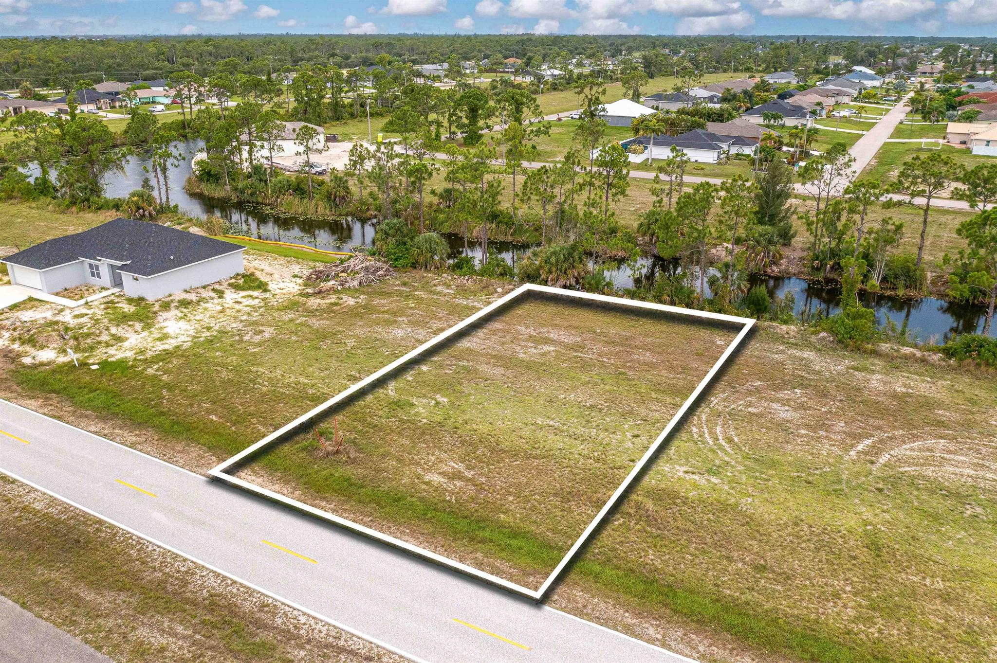 Discover this exceptional waterfront lot, ideally situated close to a variety of amenities including restaurants, shopping centers, and movie theaters. Perfect for investment or as a future home site, this property is nestled in a developing area near gated communities, the VA hospital, and nature preserves. Enjoy convenient access to US-41, Downtown Fort Myers, golf courses, beaches, and boat launches. From your backyard, you can fish, kayak, and explore the freshwater canals.