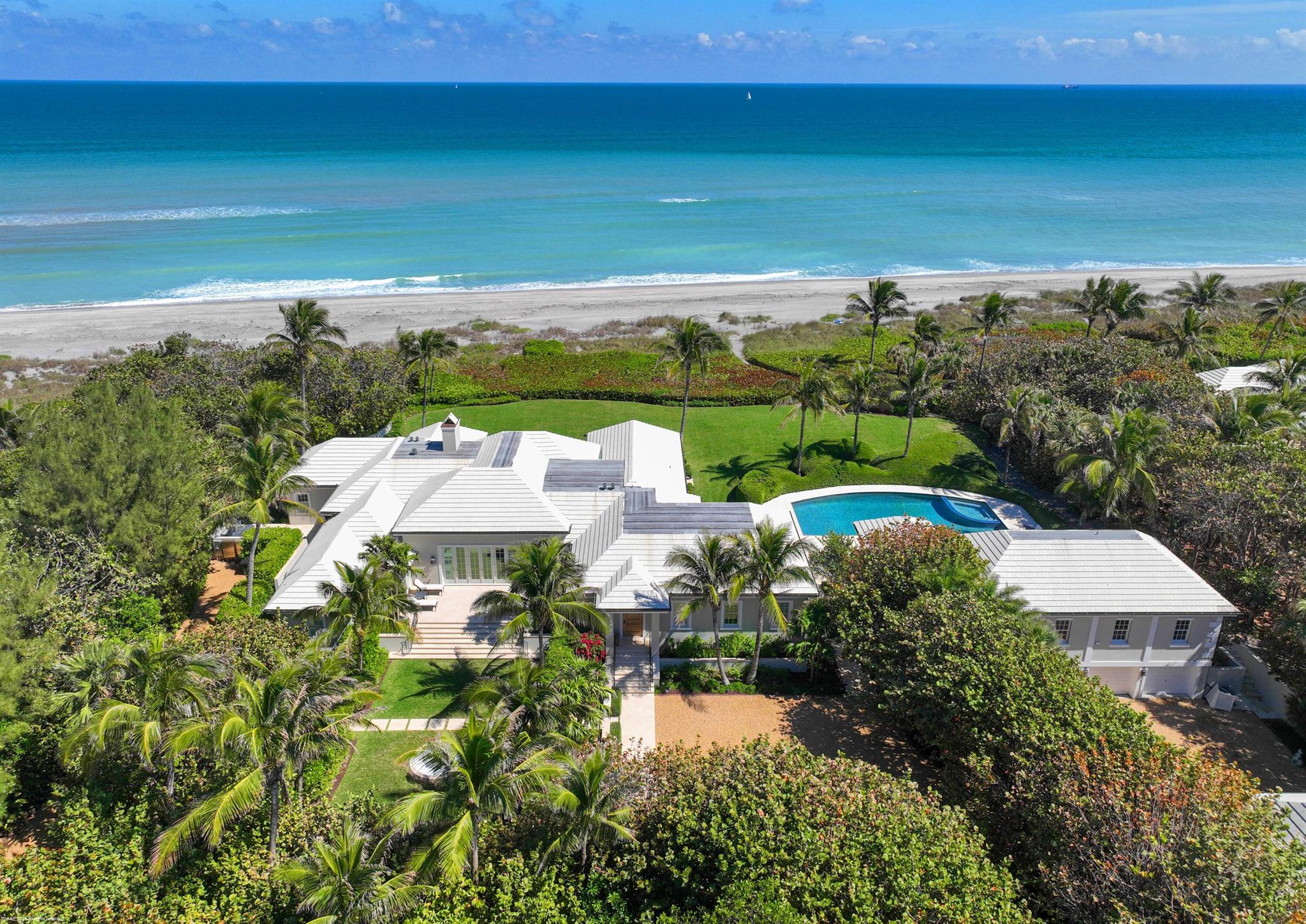 Welcome to 245 S Beach Rd. a spectacular 11 bedroom, family compound sitting on 2.2 acres with 242' of direct ocean frontage in the heart of beautiful Jupiter Island. All three structures have been completely renovated and comply to current building codes. A 19'+elevation offers undisturbed, panoramic views of the turquoise Atlantic. The main house features 5 bedrooms and multiple comfortable sitting areas (Living room, Family Room and Library) with ocean views perfect for relaxing or entertaining. There are also 2 three bedroom guest houses. Outdoors the large pool and expansive terraces connect the main house to the two guest houses. This wonderful property offers the best of tropical living with total privacy on a secluded beach.
