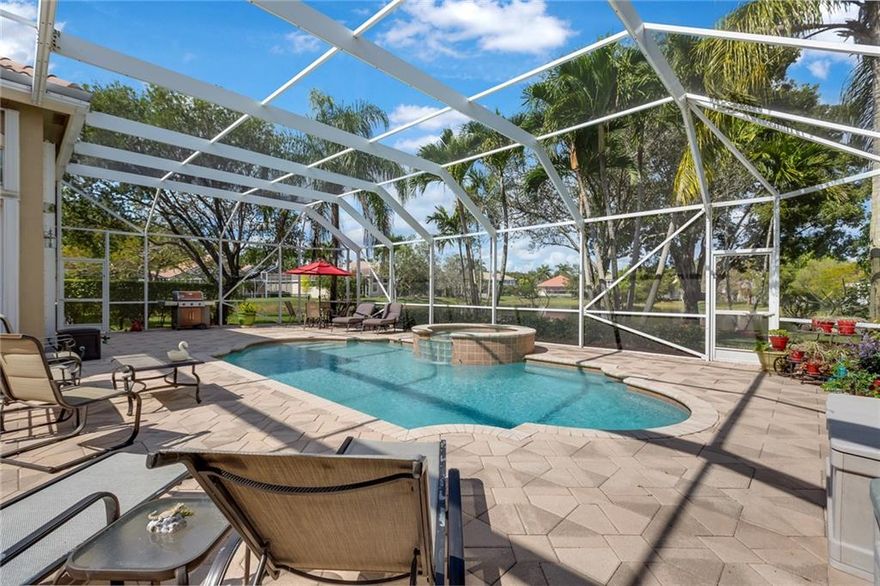 Located in the L'Hermitage division of Heron Bay this immaculately maintained pool home has 3 bedrooms 2 1\2 bathrooms, den & family room.3 car garage with built-in cabinets for extra storage. Attic is finished with wood floors ideal for storing holiday decorations.A large screened-in patio and pool overlook a tranquil lake. Sliding glass doors open from the master bedroom, living room, and family room to the pool. The gated community of Heron Bay offers resort-style amenities and access to A-rated schools.