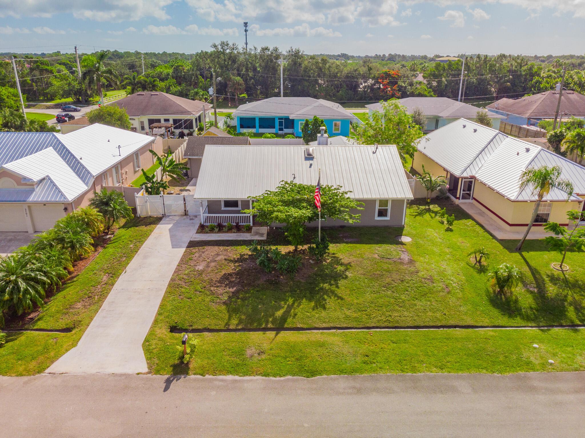 Assumable mortgage at 3.75%! This spacious 5 bed / 3 bath main home offers 2,589 sqft plus a detached 1 bed / 1 bath guest house with approx. 400 sqft. Located on a fully fenced lot, the property features all new impact windows and doors, 2019 metal roof, and fresh interior and exterior paint. Inside you'll find a modern kitchen with new appliances, high-hat lighting, upgraded ceiling fans, and stylish wall sconces. Main home A/C from 2021, guest house has a new unit, and back rooms have a separate 1.5-ton A/C. Guest house features antique wood French doors and private A/C. Motion lights, new porch fan, and more. Perfect for multigenerational living, rental income, or a private retreat!