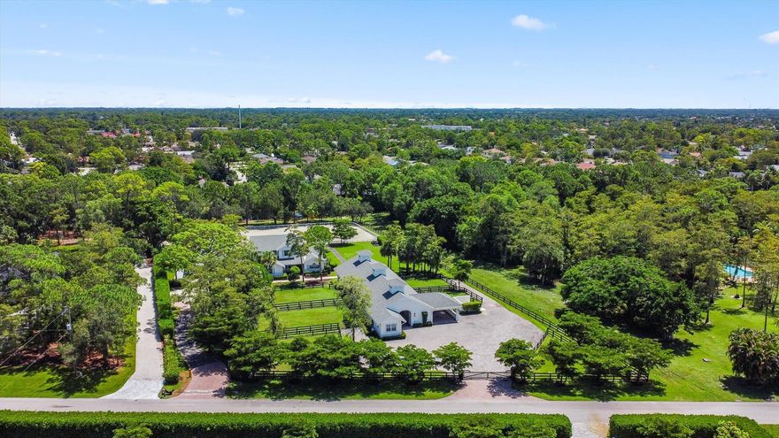 Set on just under 2.4 acres in the highly sought-after Paddock Park 2 community, this extraordinary property combines refined living with world-class equestrian amenities--all just minutes from Wellington's premier showgrounds.The spacious 5-bed, 3.5-bath residence has been beautifully refreshed with newly refinished cabinetry, new flooring, and fresh paint inside and out. A brand-new pool deck, resurfaced pool, updated fencing, lush landscaping, and a modernized exterior create a true turnkey home designed for both comfort and style.For the equestrian, the property delivers exceptional facilities: a 10-stall center-aisle CBS barn complete with a staff apartment, rider's lounge, covered wash and grooming stalls, plus dedicated tack, feed, and laundry rooms.  An expansive 210' x 100'