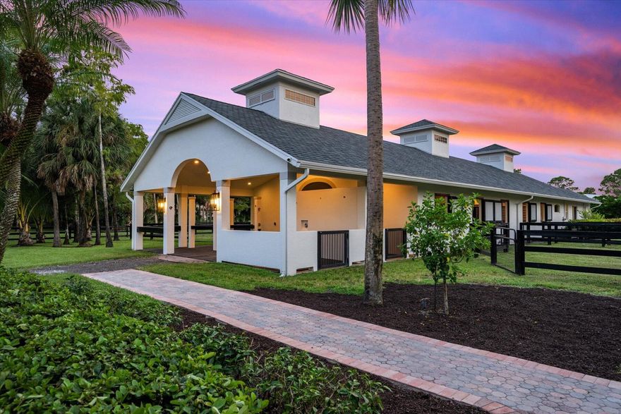 Set on just under 2.4 acres in the highly sought-after Paddock Park 2 community, this extraordinary property combines refined living with world-class equestrian amenities—all just minutes from Wellington's premier showgrounds.
The spacious 5-bed, 3.5-bath residence has been beautifully refreshed with newly refinished cabinetry, new flooring, and fresh paint inside and out. A brand-new pool deck, resurfaced pool, updated fencing, lush landscaping, and a modernized exterior create a true turnkey home designed for both comfort and style.
For the equestrian, the property delivers exceptional facilities: a 10-stall center-aisle CBS barn complete with a staff apartment, rider's lounge, covered wash and grooming stalls, plus dedicated tack, feed, and laundry rooms.  An expansive 210' x 100' arena with a GGT fiber footing mix provides the perfect environment for training and competition, while six paddocks (with room to add more) ensure ample turnout space.
Offering the rare balance of luxury living and professional-grade equestrian infrastructure, this property is more than a home it's a private retreat designed for the dedicated rider.