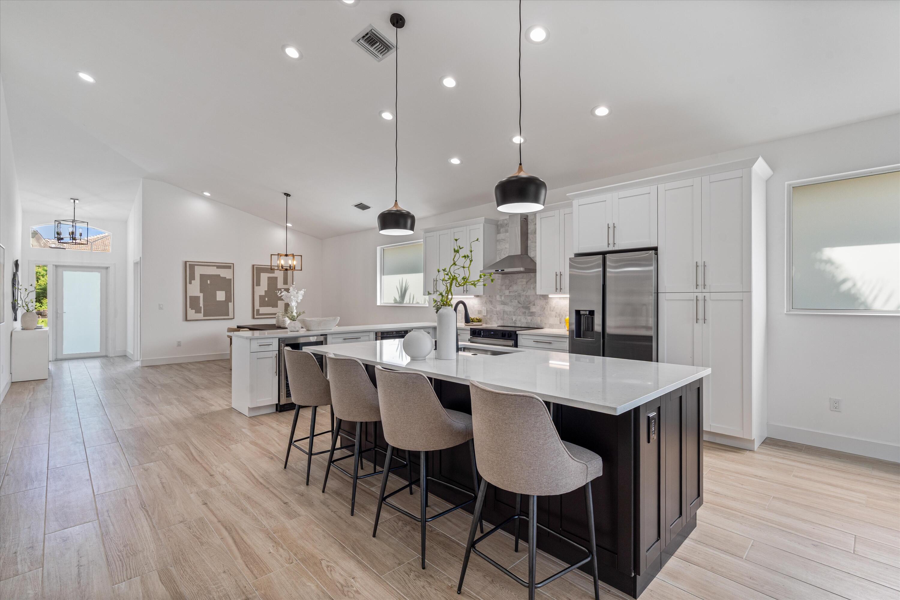 A not-to-be-missed opportunity to own a like-new, completely upgraded 4 bedroom home with over 2,300 square feet of refined living space. From the moment you arrive, you'll notice that no detail has been overlooked! This home exudes quality, elegance, & thoughtful design.Enjoy complete storm protection w/ FULL IMPACT WINDOWS & DOORS and a BRAND NEW ROOF, offering both peace of mind & elevated curb appeal. The chef's kitchen is a true showpiece, featuring a suite of top-tier stainless steel appliances, including wine fridge, dramatic designer hood, all perfectly complemented by custom cabinetry & premium finishes.The interior is a study in sophistication, with designer-curated bathrooms w/ freestanding tub, frameless walk-in shower, that evokes spa-like luxury.