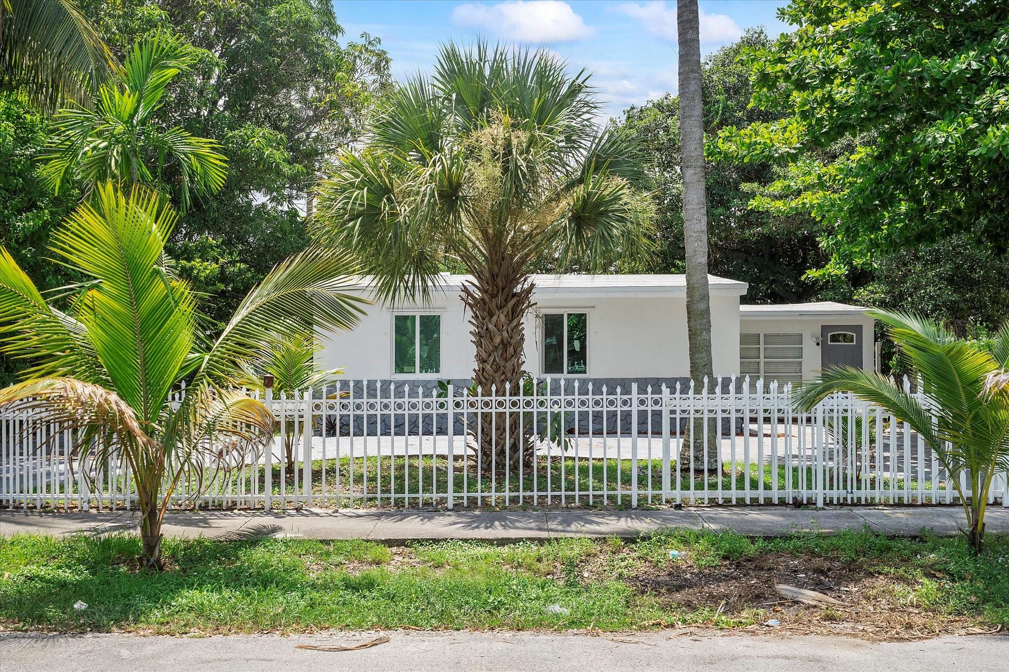 Welcome to your West Park home, offering comfort, style, and peace of mind with no HOA fees or restrictions. An extended driveway provides ample parking, while the fenced backyard features four fruit trees, a majestic banyan, and plenty of room to add a pool or create your dream retreat. The screened patio is perfect for relaxing outdoors. Inside, you’ll find 3 bedrooms, a full bath with walk-in shower, and a living room with custom wall accents and dining space. Recent upgrades include impact windows and doors with shutters, a new roof, new plumbing, updated lighting and wiring, new flooring, upgraded central AC, new washer and dryer, and exterior lighting. With its modern updates and ideal location, this home is perfect as a primary residence or investment.