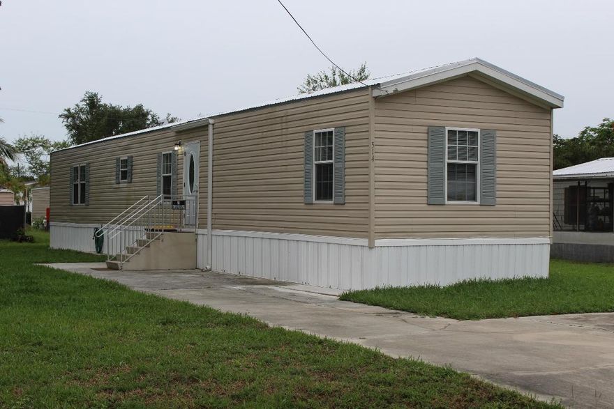 3/2 Mobil home on a .18 acre lot included with sale along with large storage shed. new laminate flooring ready to show.