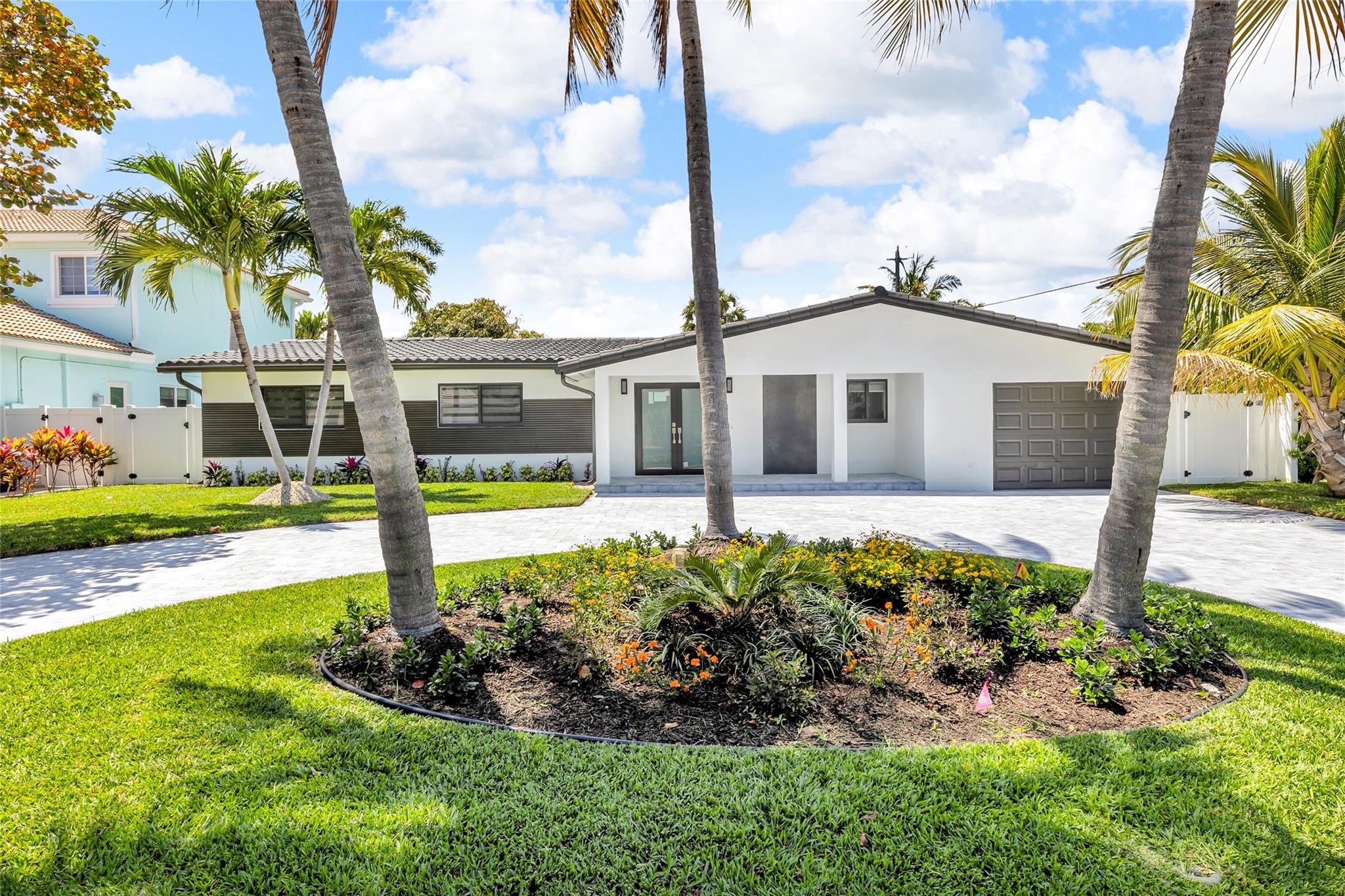 4 BR 2 BA home in the highly sought-after Lake Placid subdivision of Lighthouse Point. 2025 remodeled with all the stylish neutral tones of greys, beige, white and chocolate exterior accents The grandness of the open concept will impress, and the added features:custom closet systems, modern style cabinets, tiled wood-look flooring throughout, sparkling new kitchen appliances, a water-fall quartz Island seating 4 to 6, plus separate dining area. An oversized 1-car garage leads to a spacious laundry/mud room equipped with new washer and dryer equipment. All new plumbing, electric panel, sprinkler system, impact windows & doors, circular driveway and pavers, all in compliance with current codes. Enjoy the outdoor living experience in the fully fenced and sodded backyard with an oversized Shed